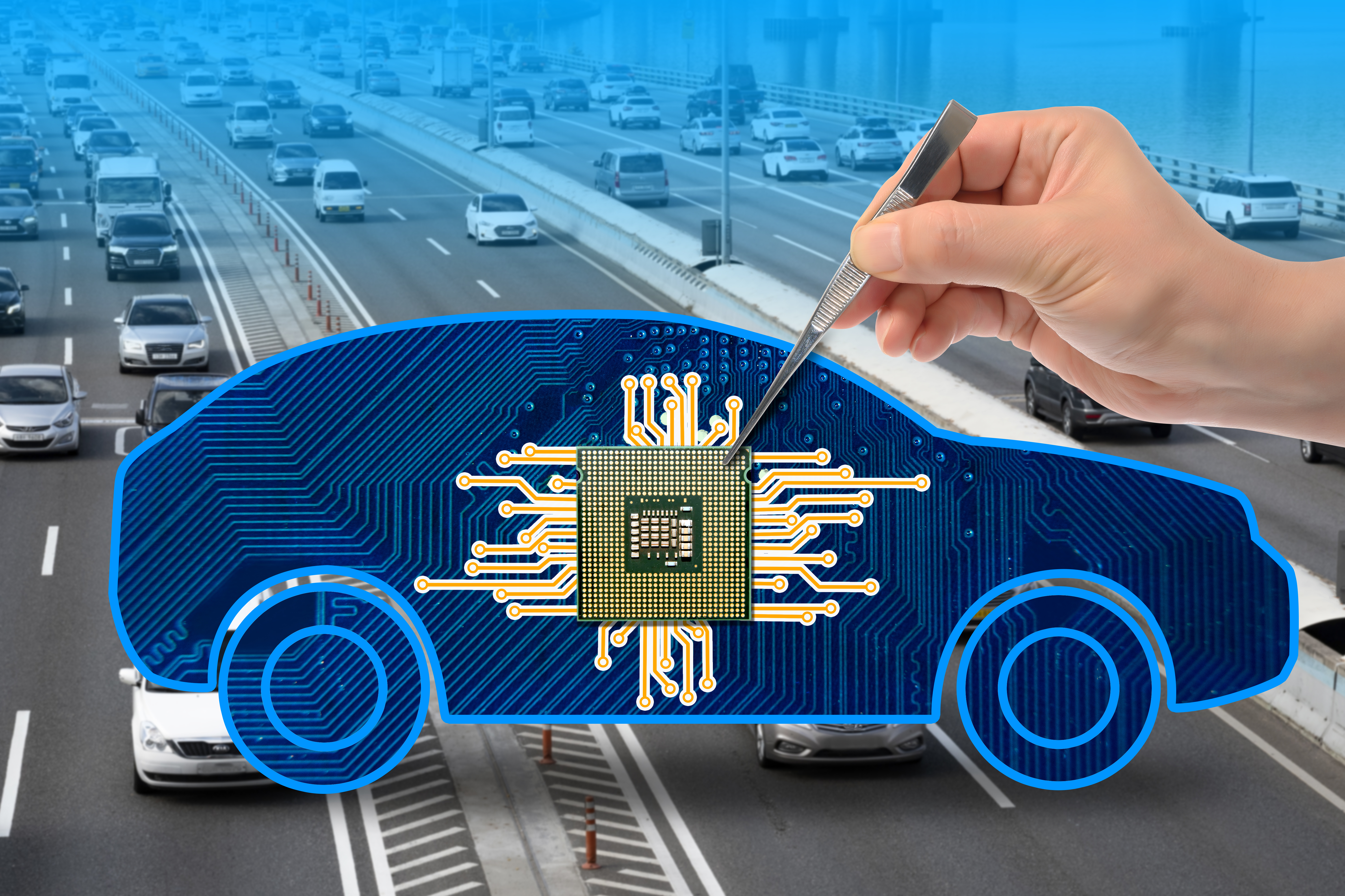A human hand placing a computer chip at the center of a digitally rendered car, imposed over a real life highway system