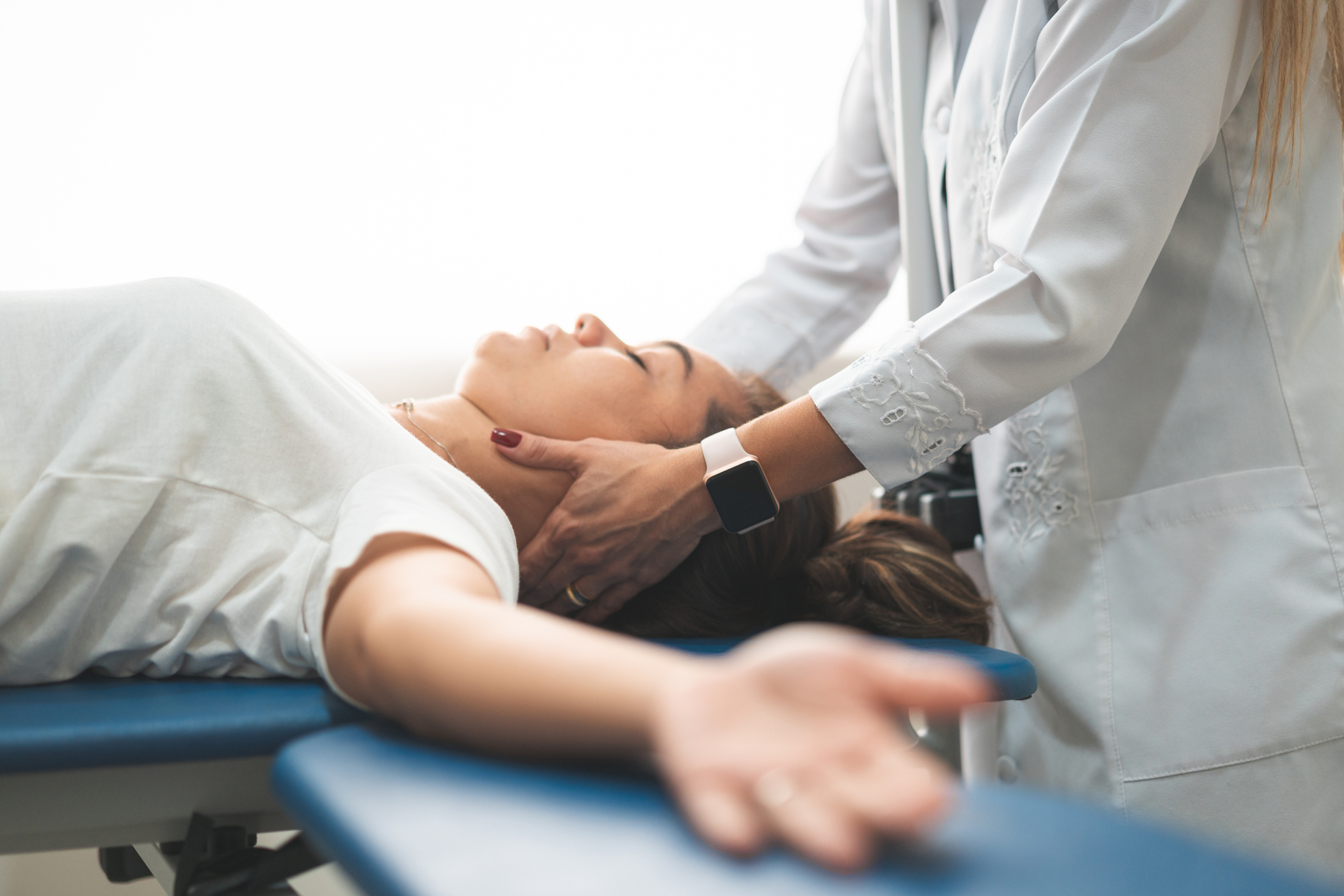 chiropractor working on patient's neck