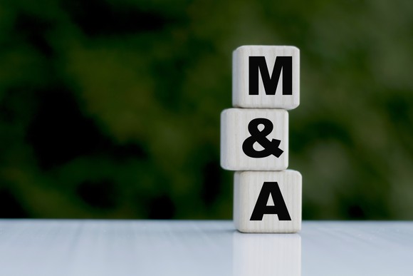 Stacked wooden blocks that spell M&A.