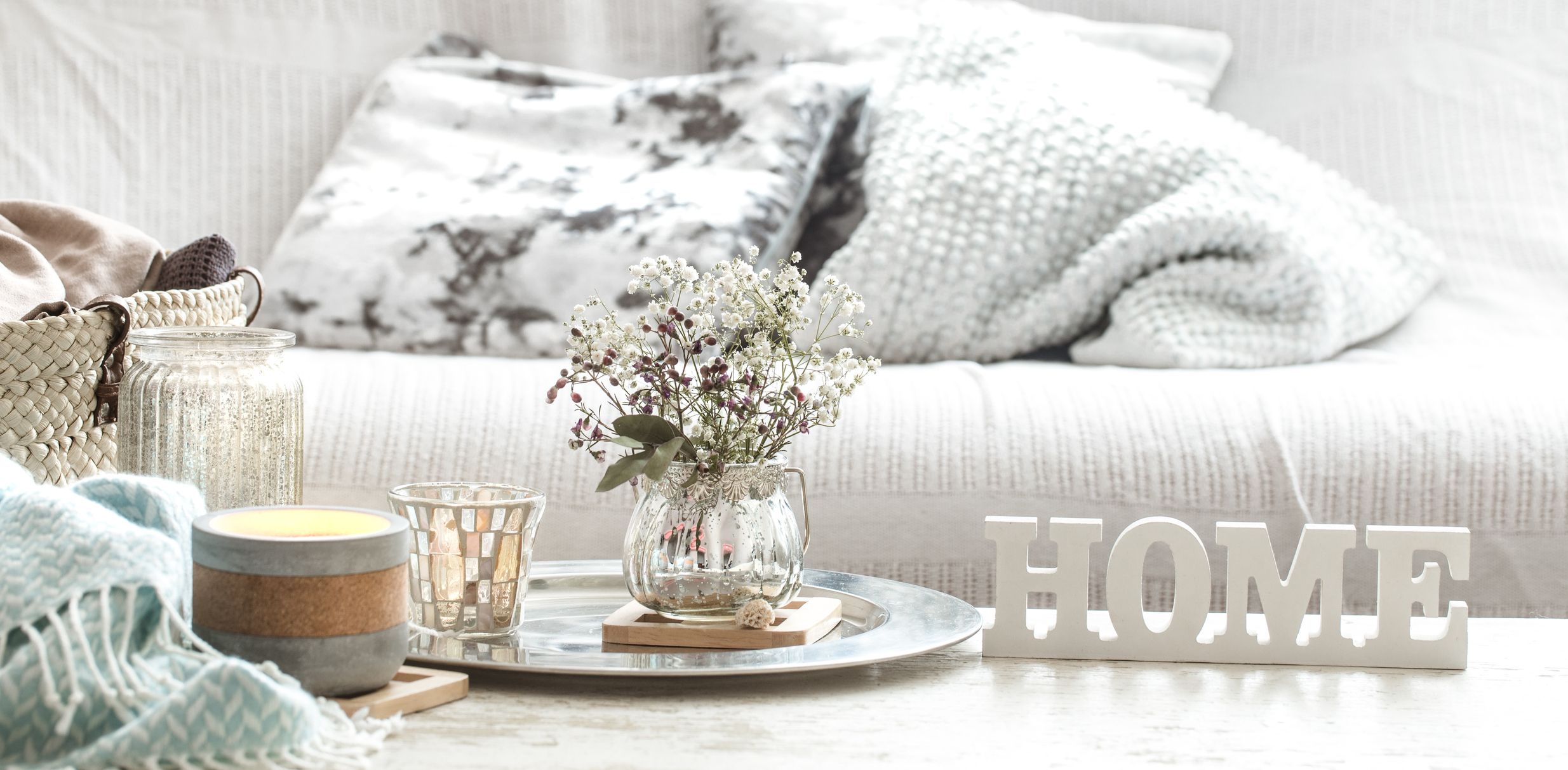 An array of home decor items, with a couch in the background.