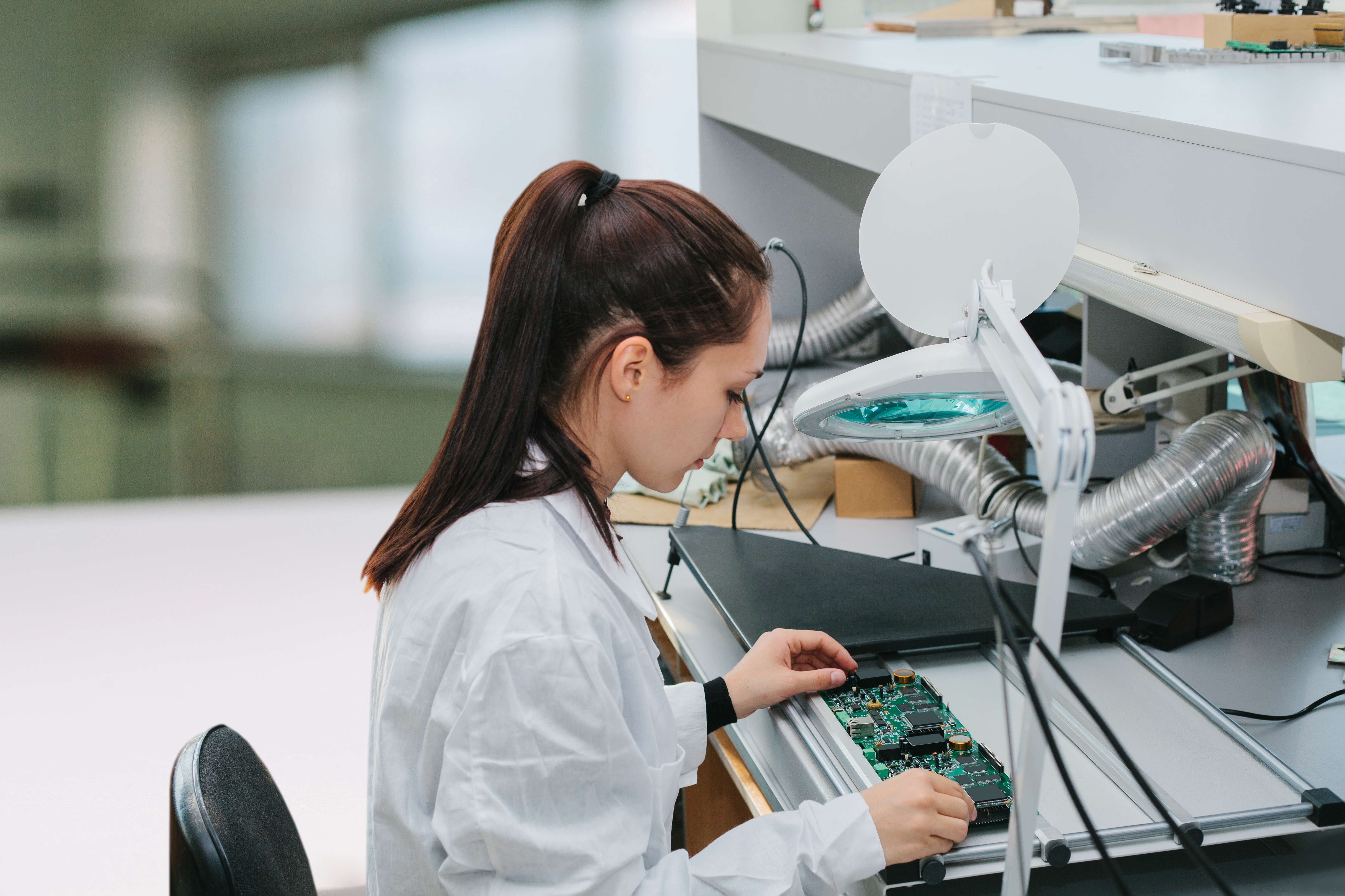 A semiconductor manufacturing worker inspecting a computer chip.