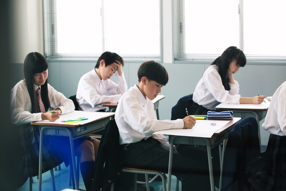 Students in a classroom sitting at desks while working.