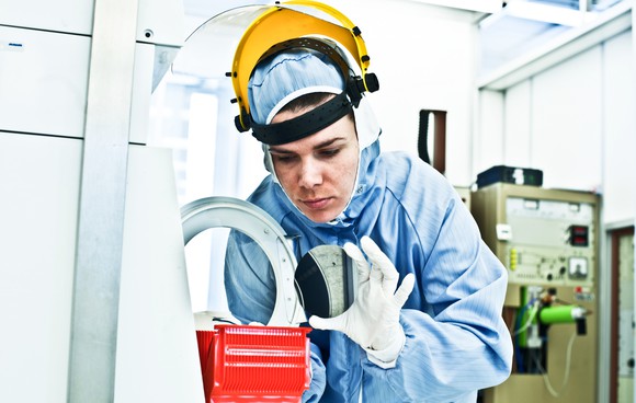 Engineer inspecting with semiconductor manufacturing process.