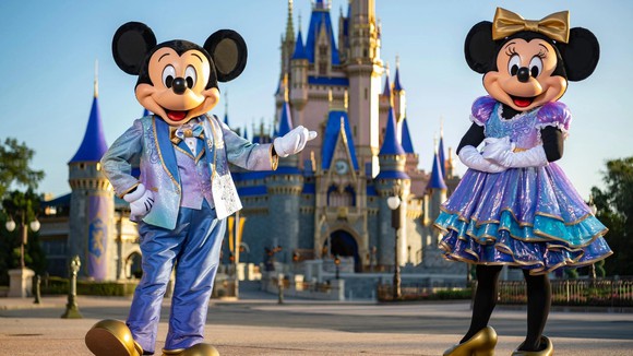 Mickey and Minnie Mouse in front of Cinderella Castle at Disney World's Magic Kingdom.