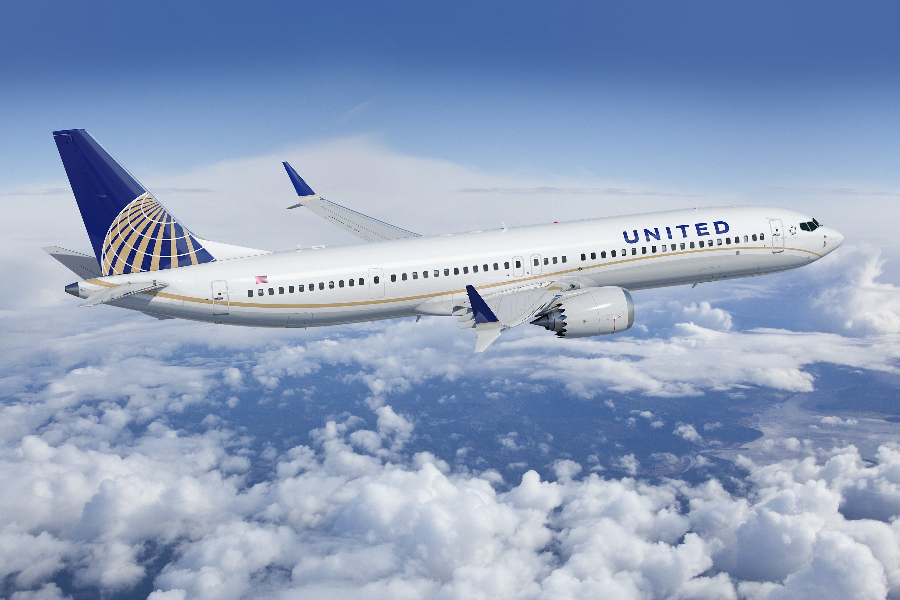 A United Airlines jet flying over clouds.