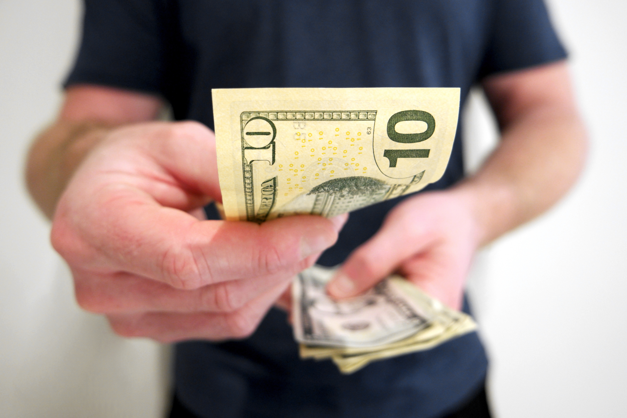 Person counting out cash.