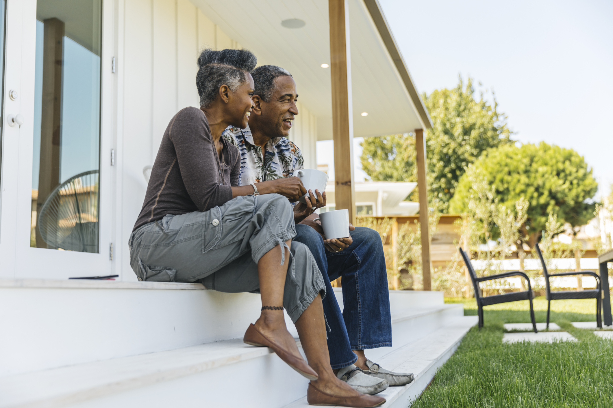 retired couple sitting on porch steps