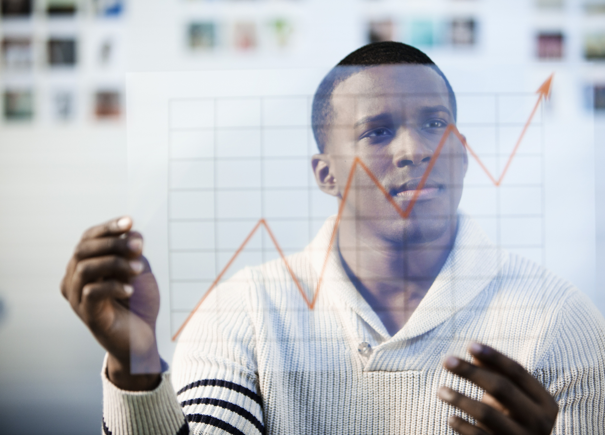 A person looking at a chart going up.
