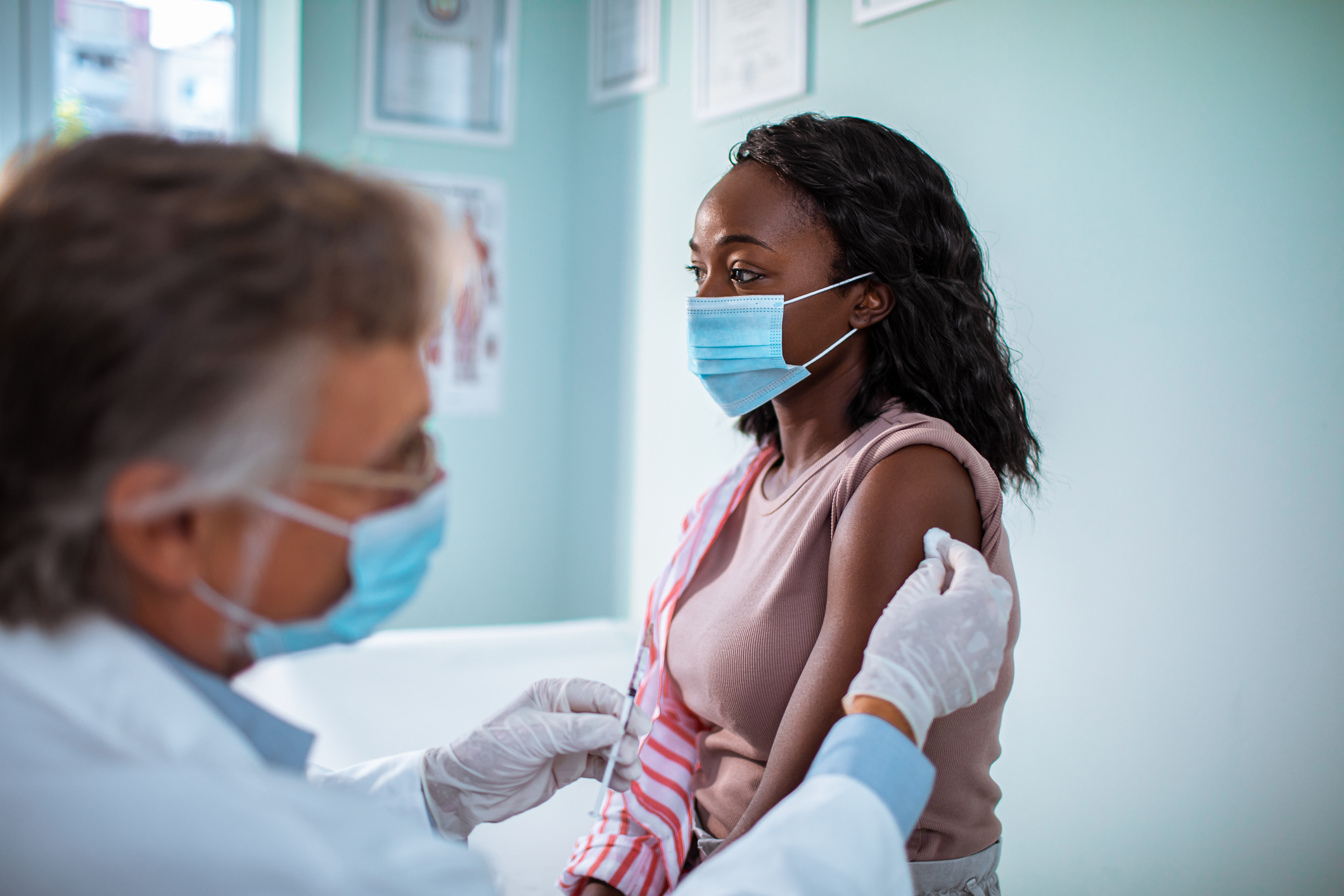 Doctor vaccinating a patient.