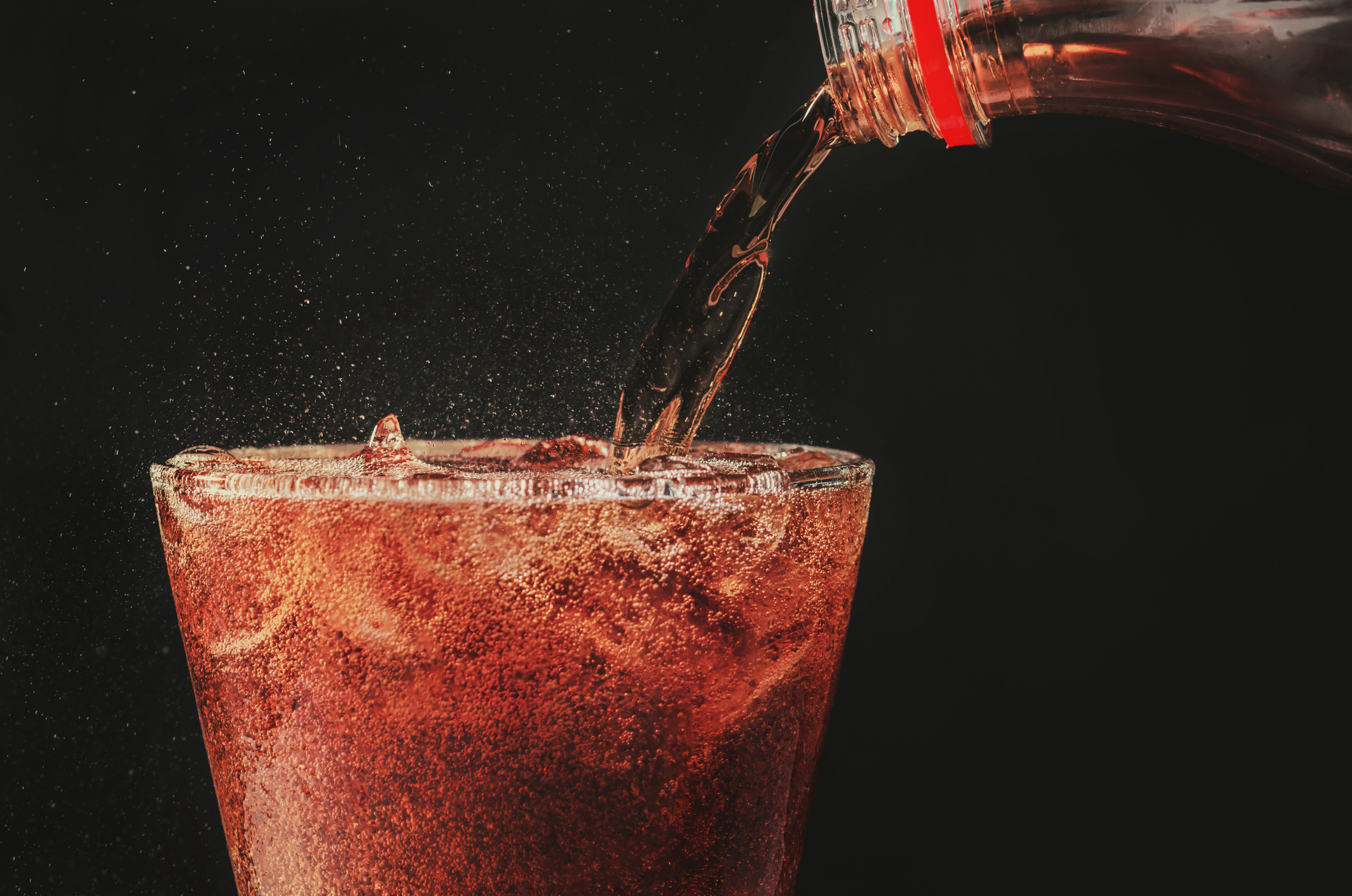 Soda being poured in a glass.