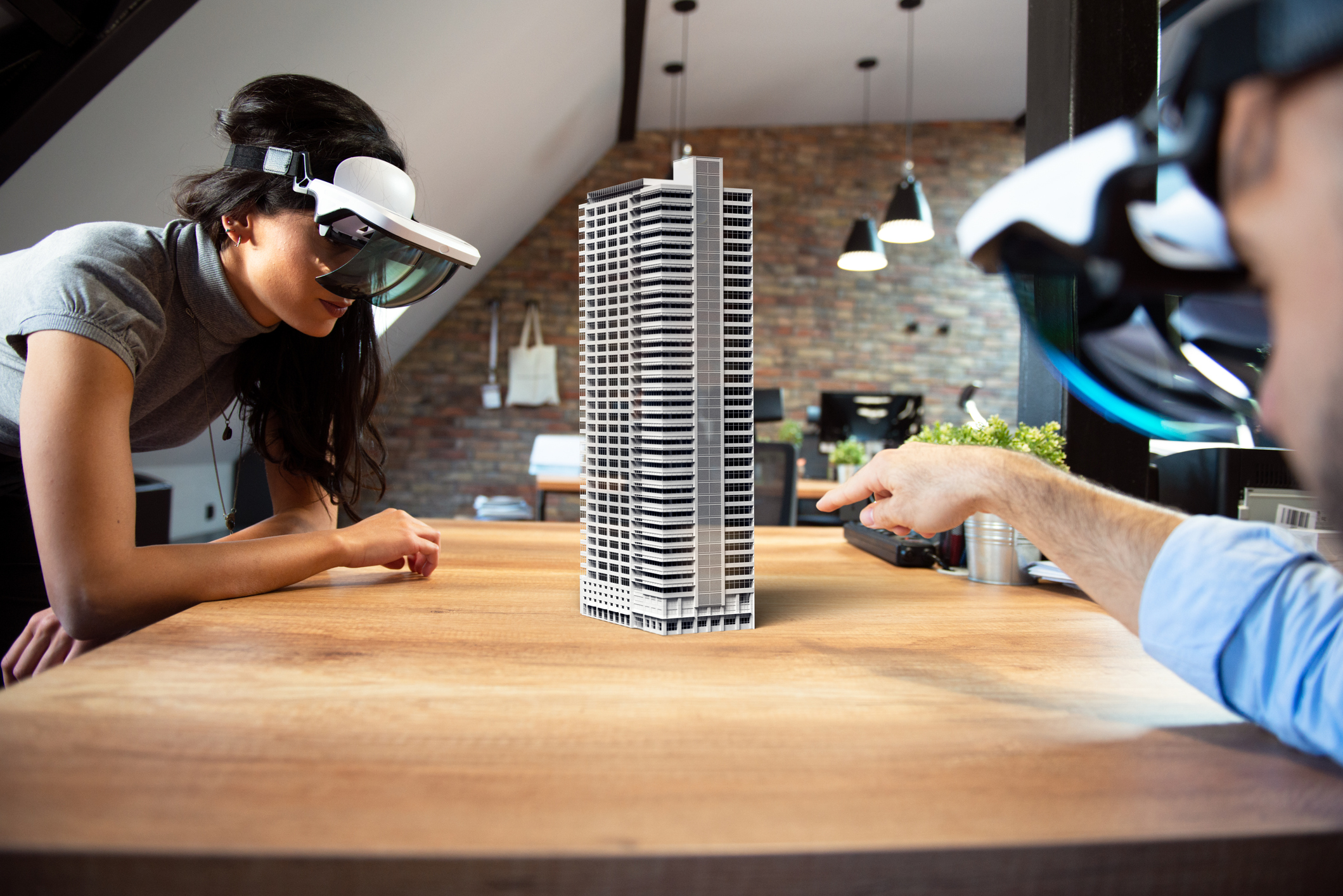 two people wearing VR goggles interacting via augmented reality