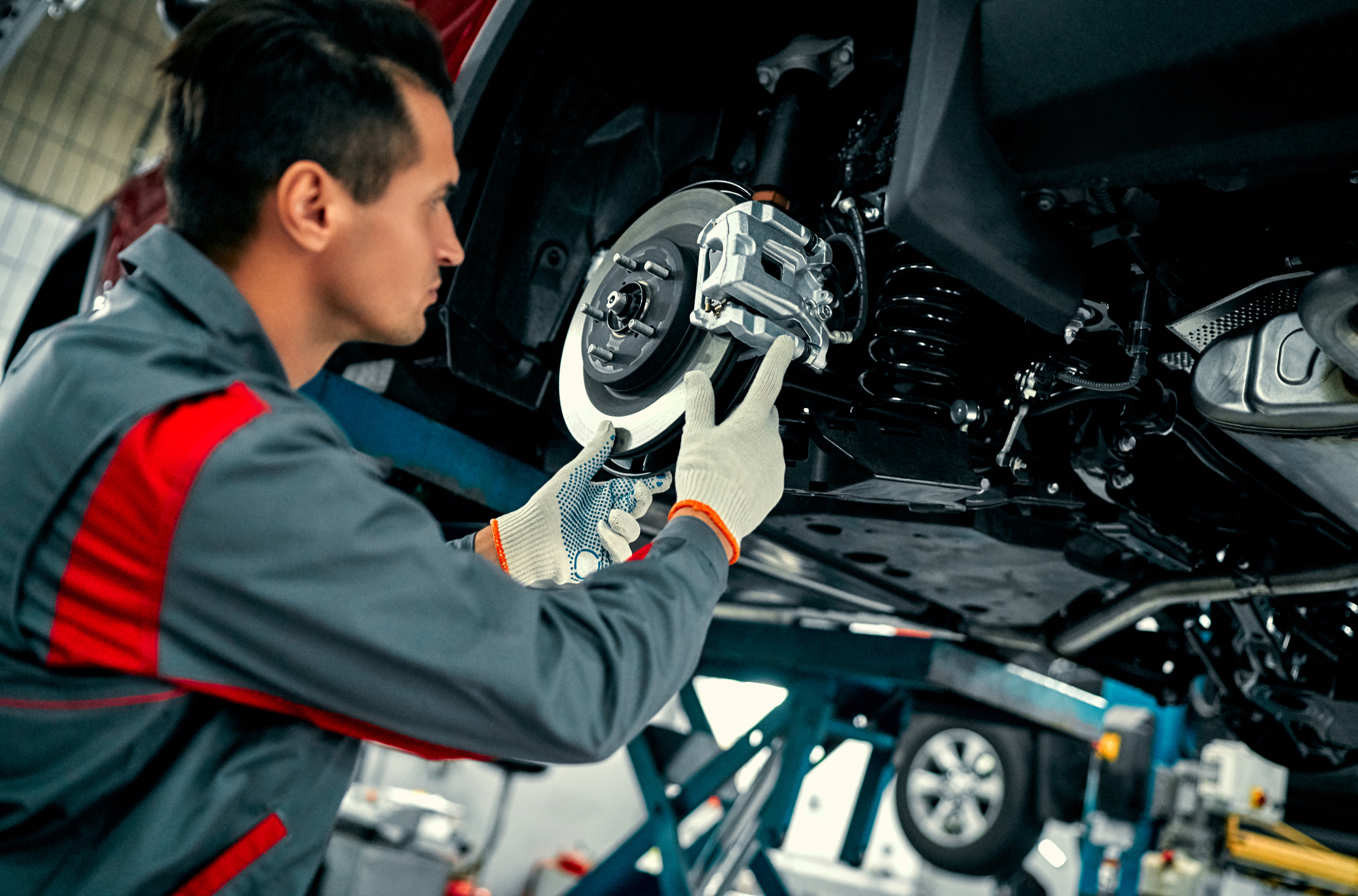 Auto mechanic installing a brake.