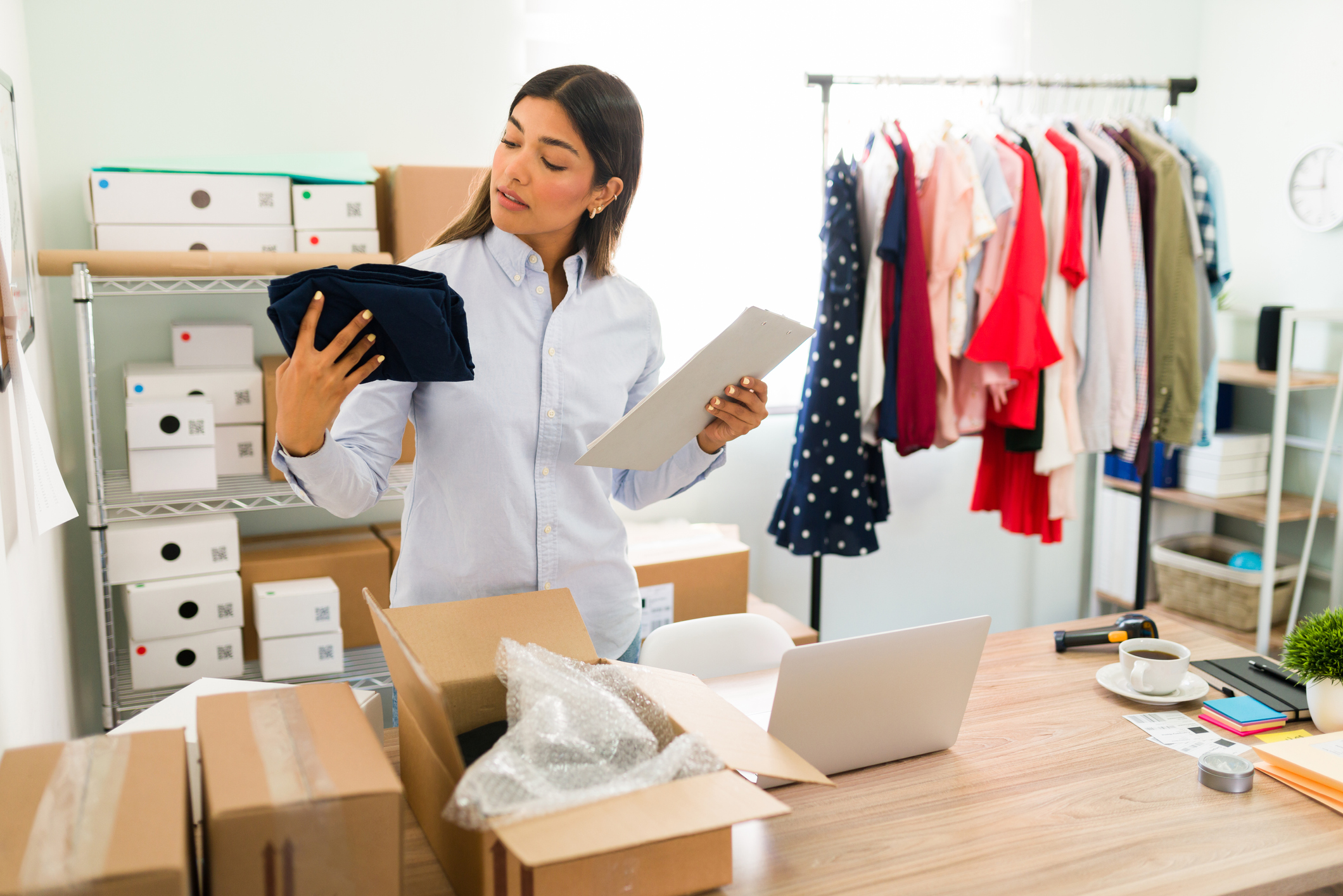 A store owner prepares to ship orders to customers