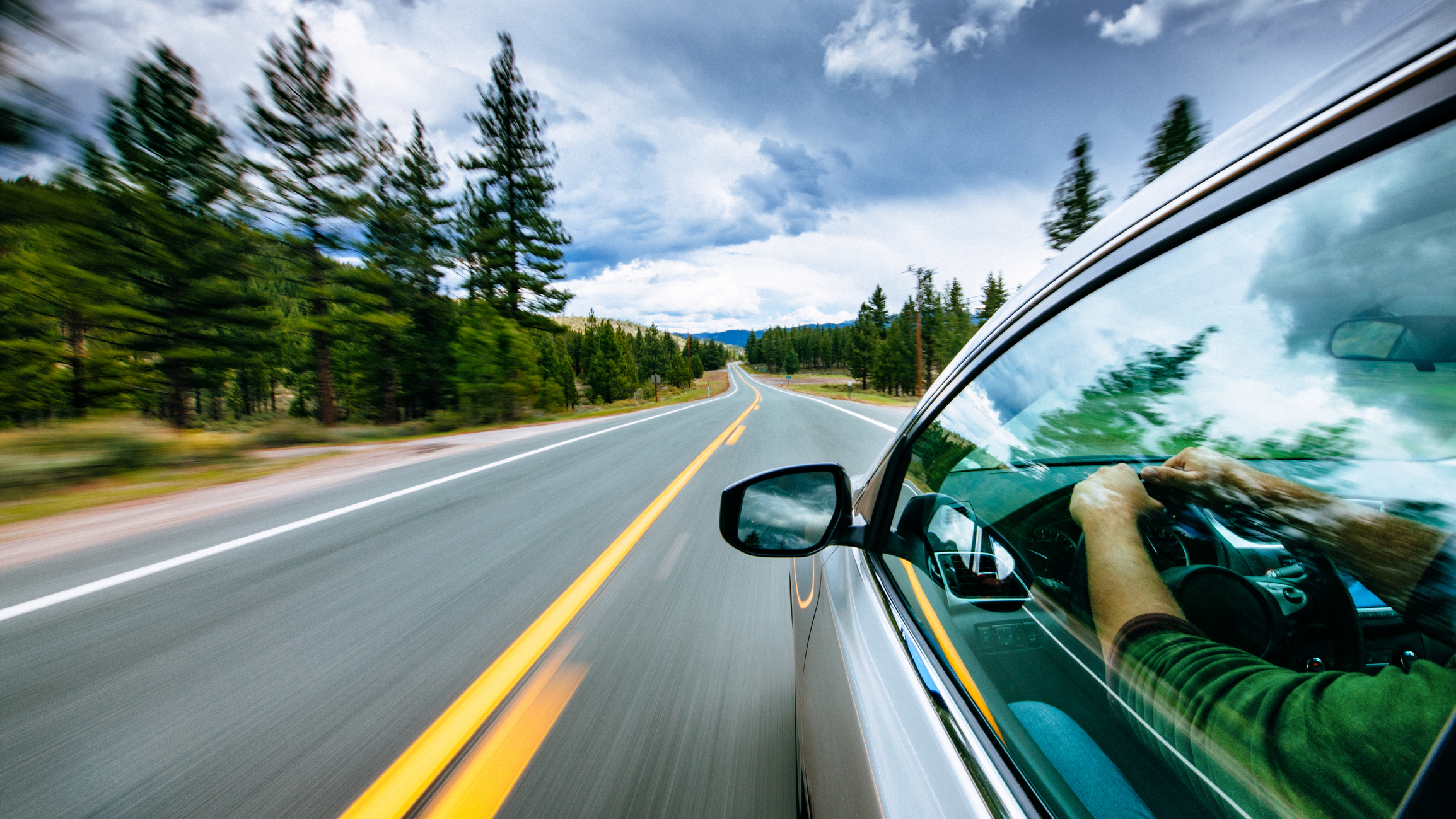 A car driving down an open highway.
