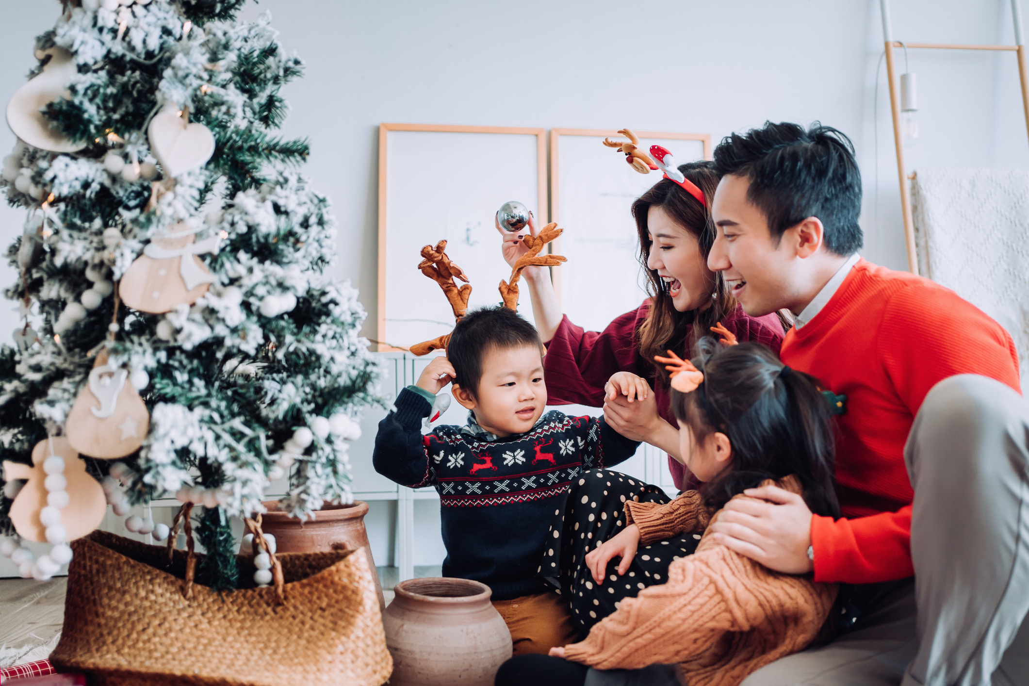 Family at home decorating for Christmas.