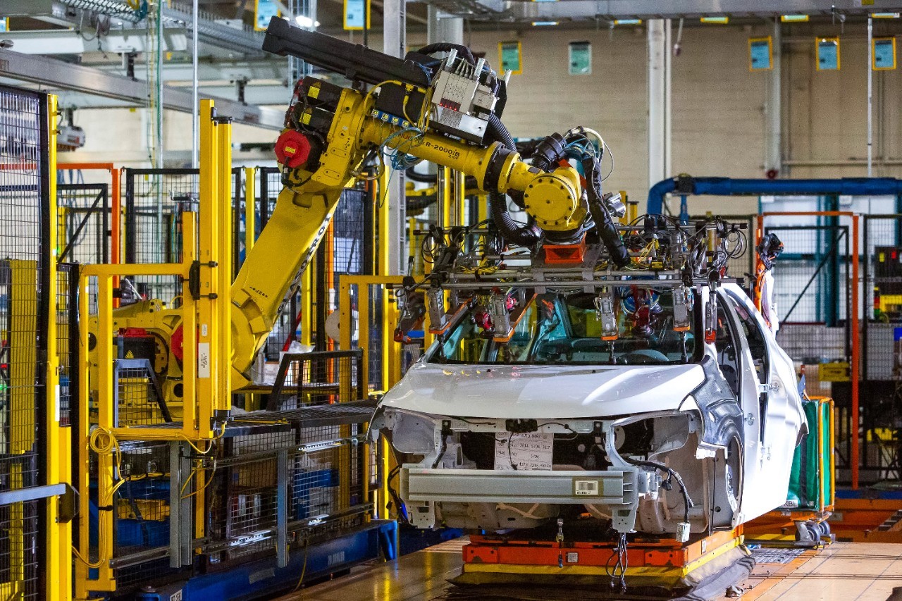 A vehicle being assembled in a manufacturing plant. 