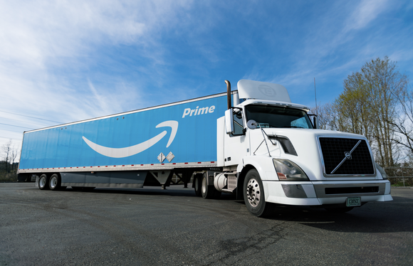 Amazon Prime delivery truck against a blue sky background. 