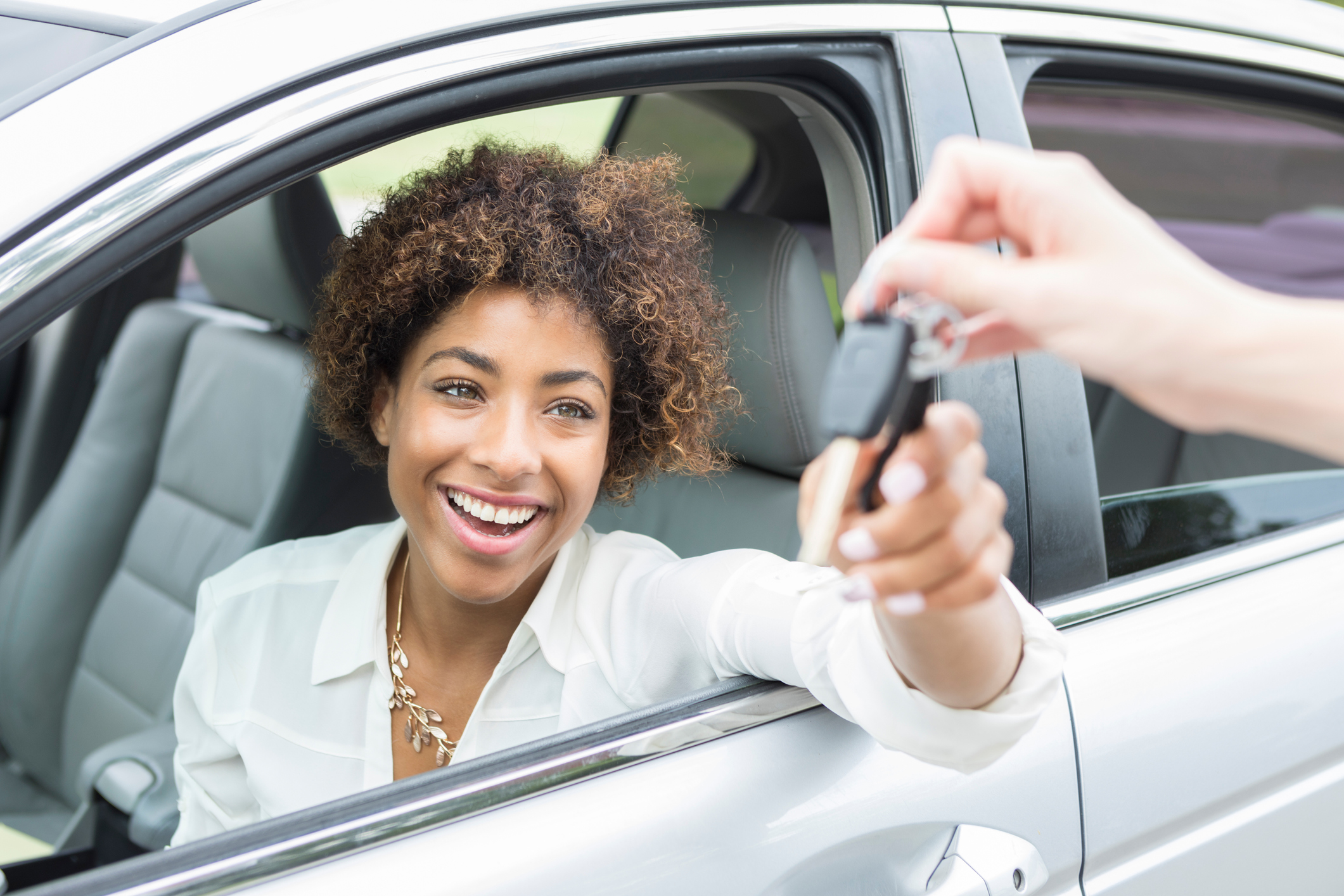 A customer receiving the keys to their new car.