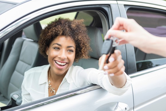 A customer receiving the keys to their new car.