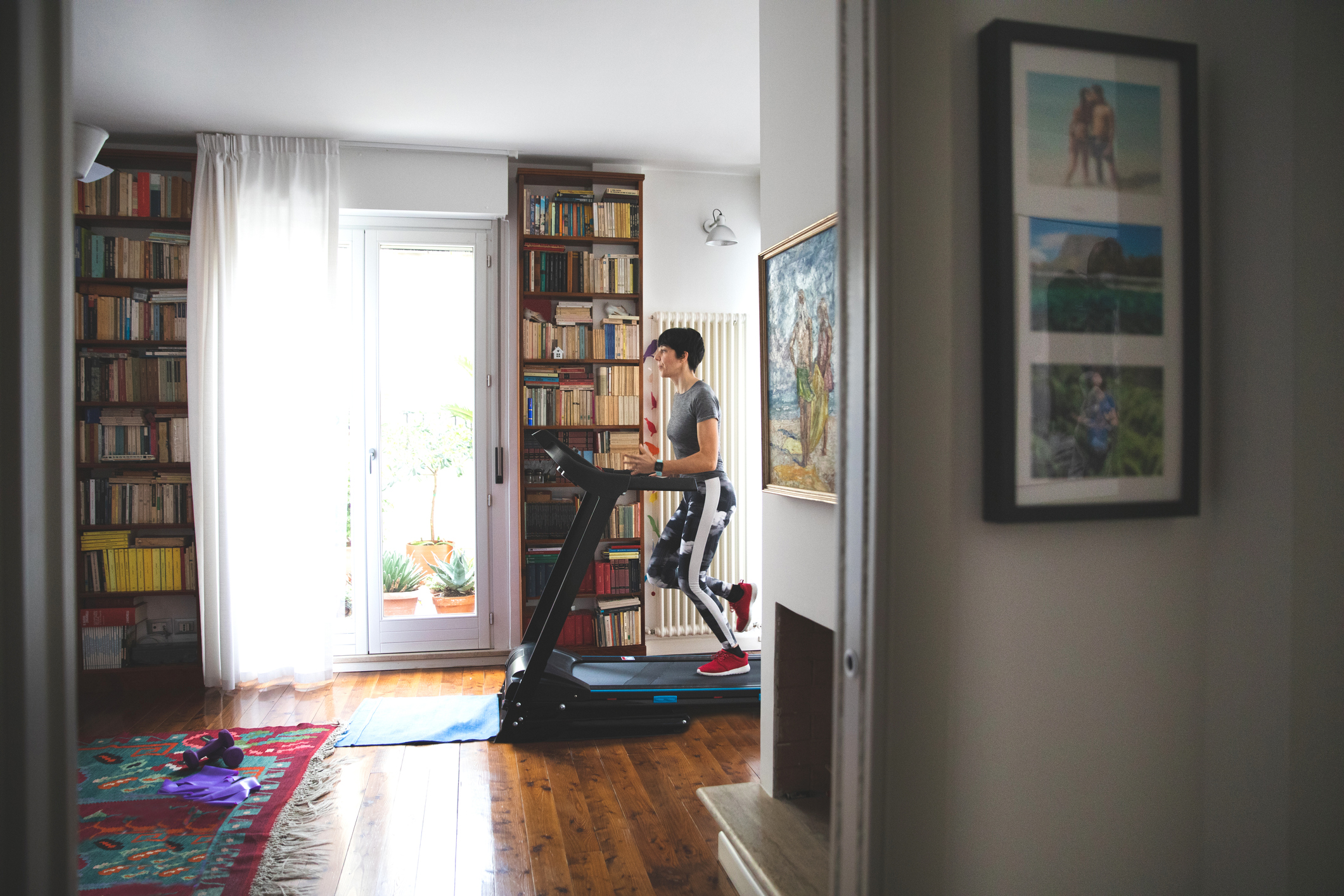 Person running on a treadmill at home.