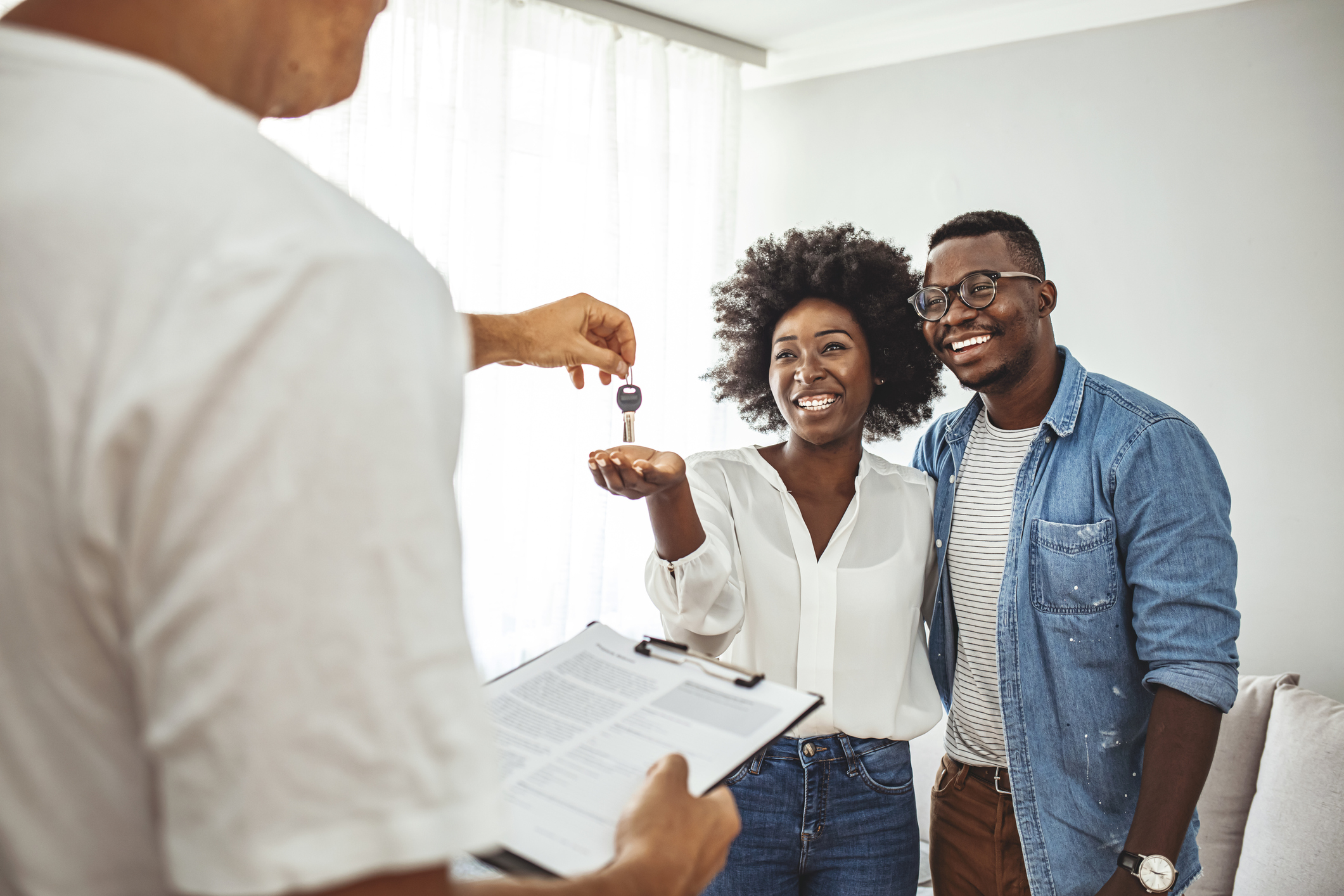 Two people getting keys from a third person.