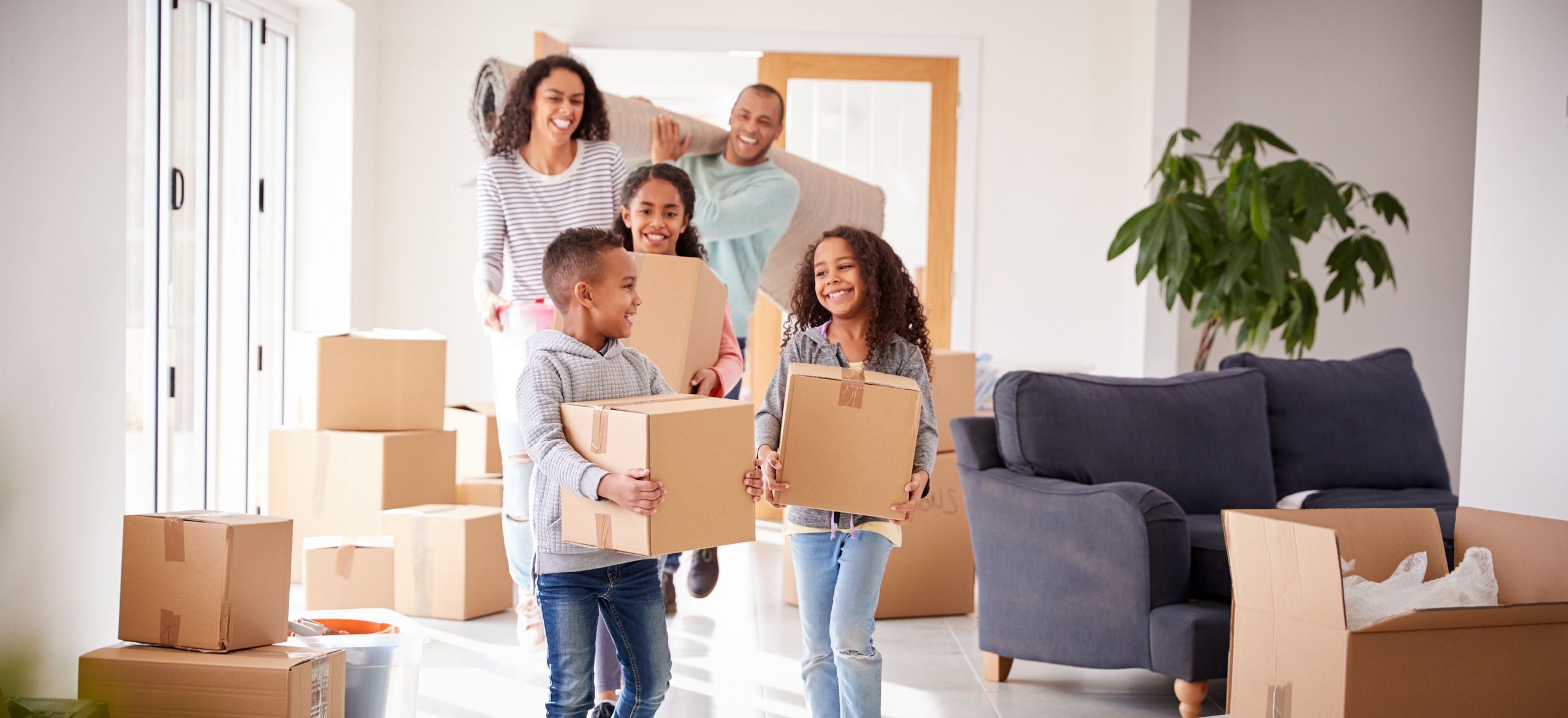 A family unpacking boxes in their new house.