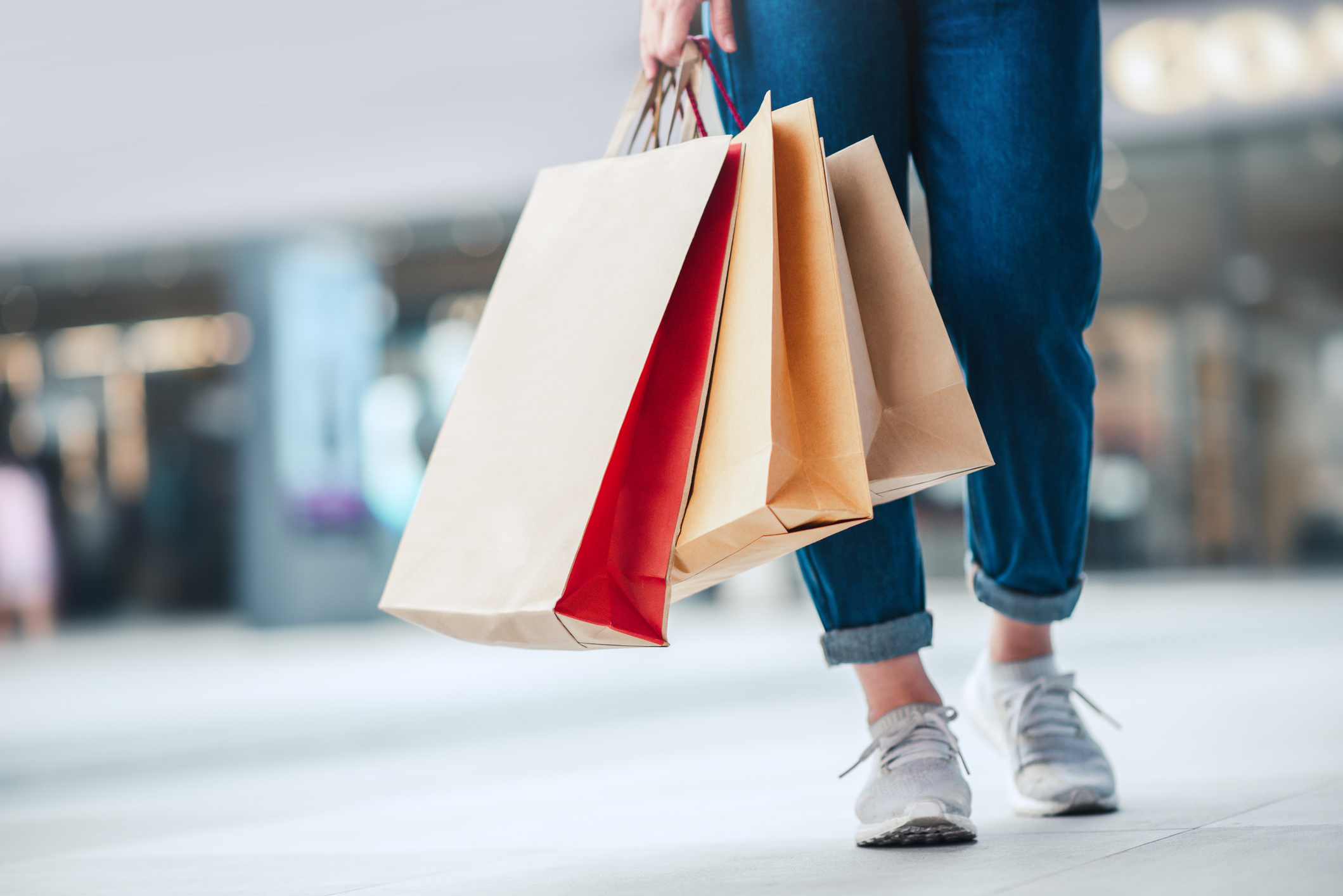 Person walking with shopping bags.