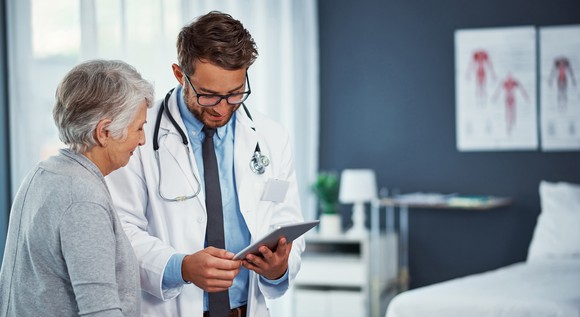 Doctor showing a patient their chart.