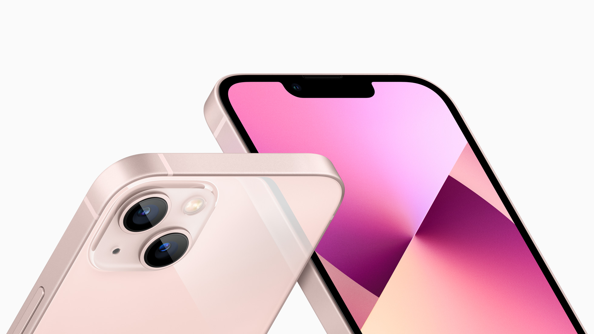 Two rose colored iPhone 13s resting diagonally showing front and back view.