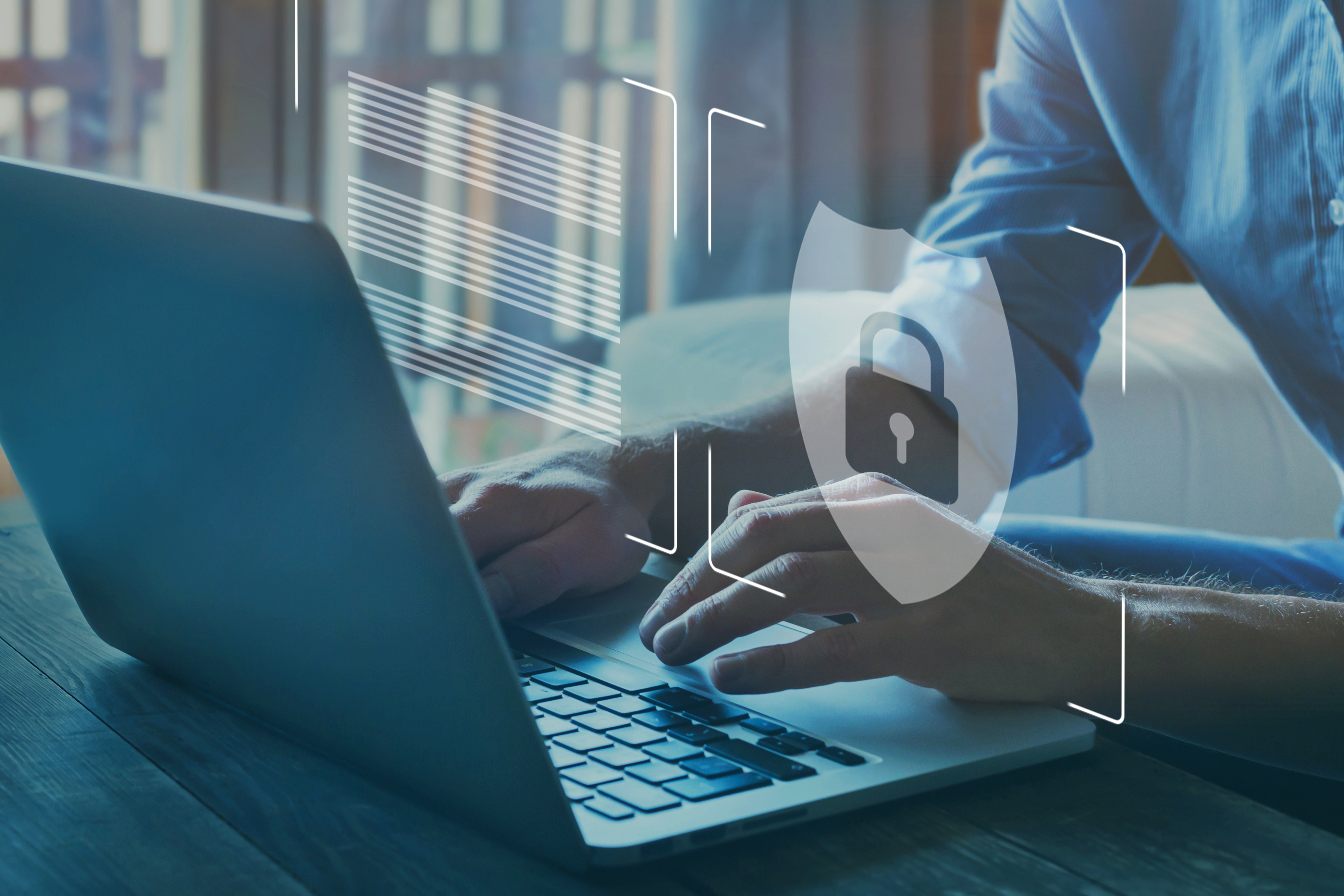 Person on laptop with cyber security symbol