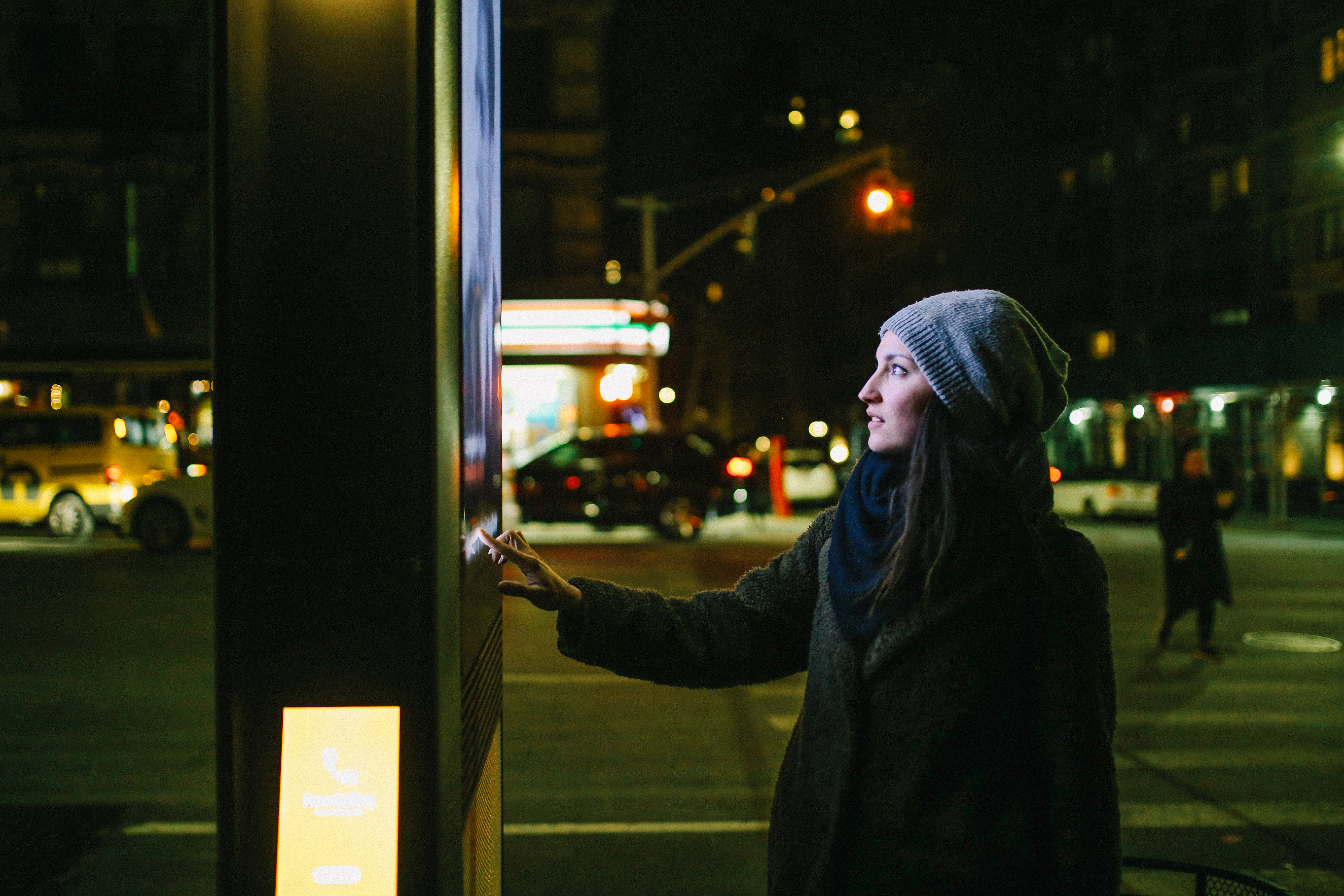 Someone using a digital kiosk in a city.