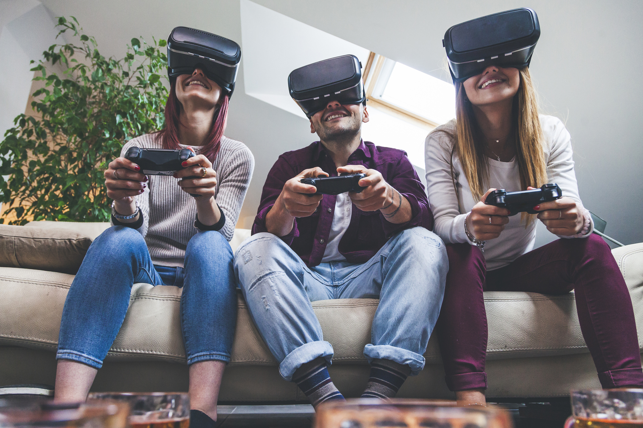 Three friends gaming with VR headsets.