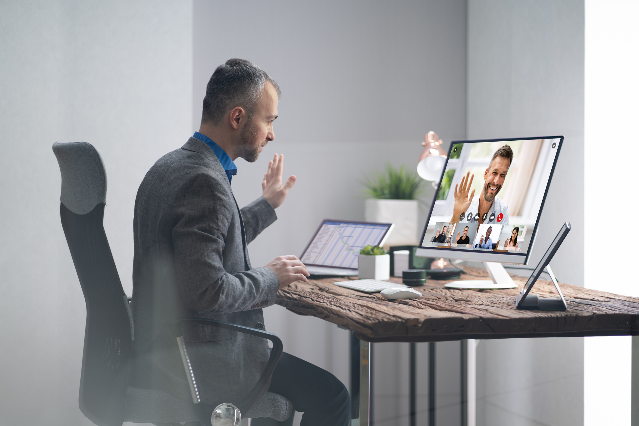 A businessperson using a webcam in a virtual meeting.