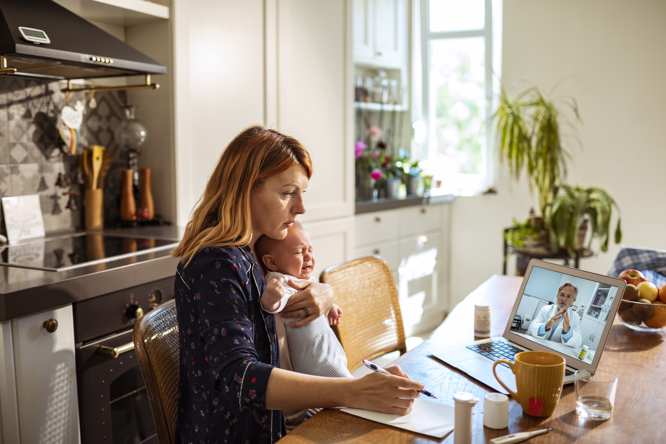 Woman with child on video call with doctor