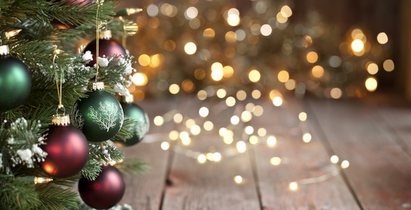 A Christmas tree next to some blurry lights
