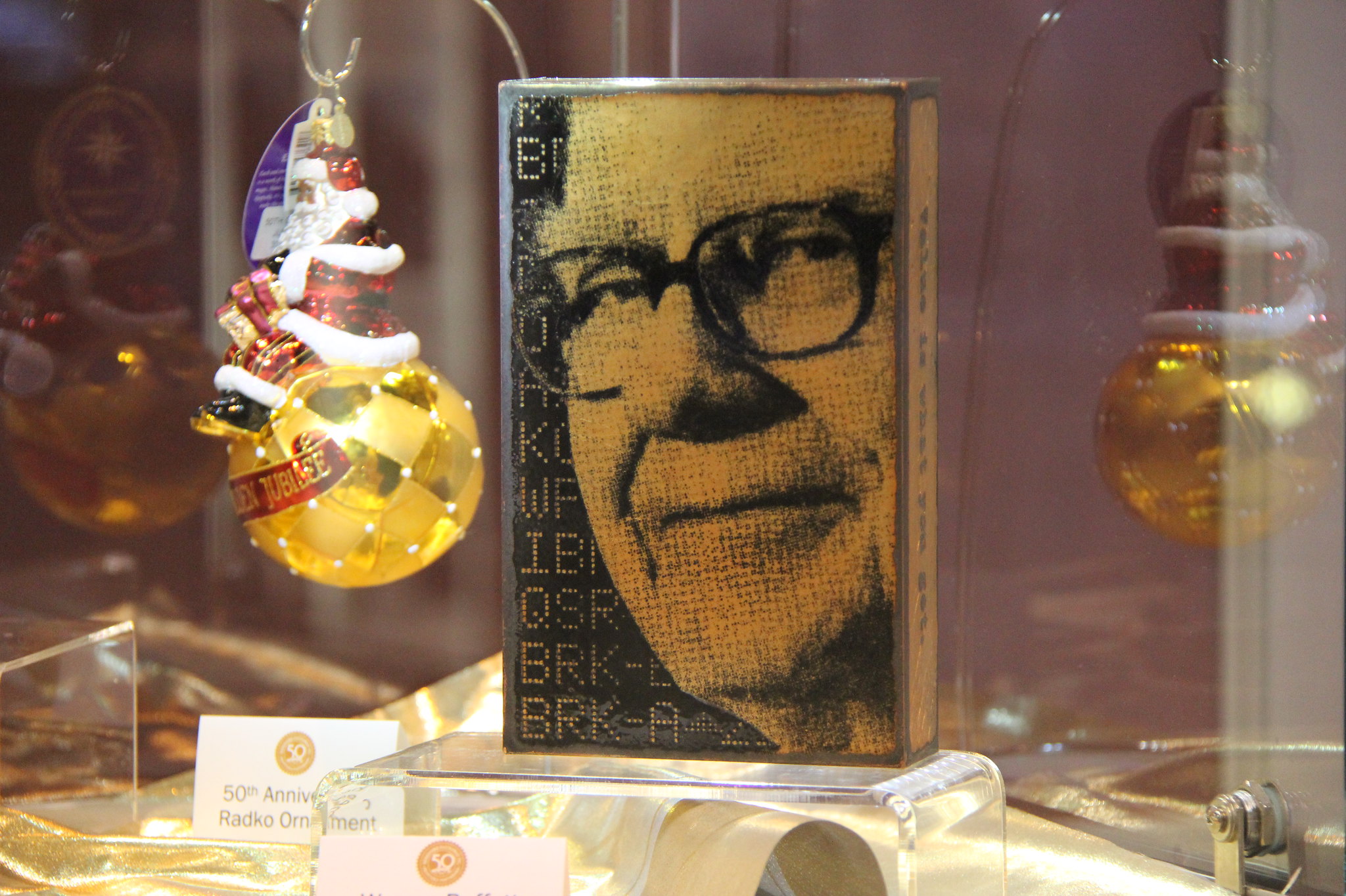 A Warren Buffett photo next to a Christmas ornament.