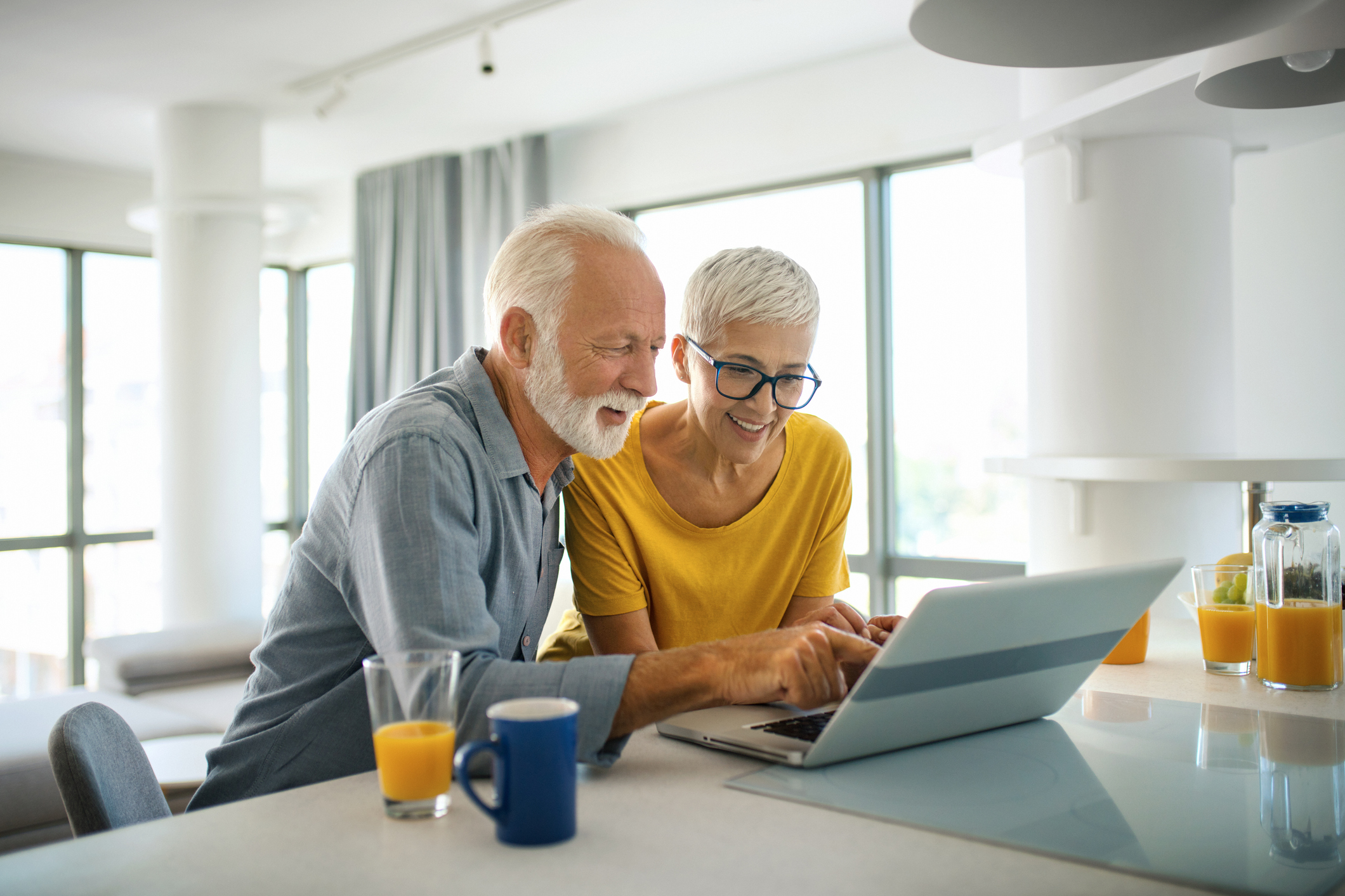 Two people looking at a laptop screen.