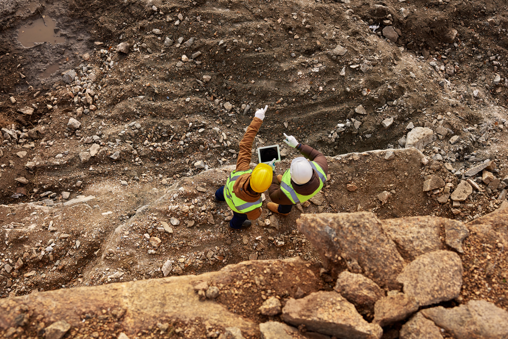 Two people looking out at a mining site.