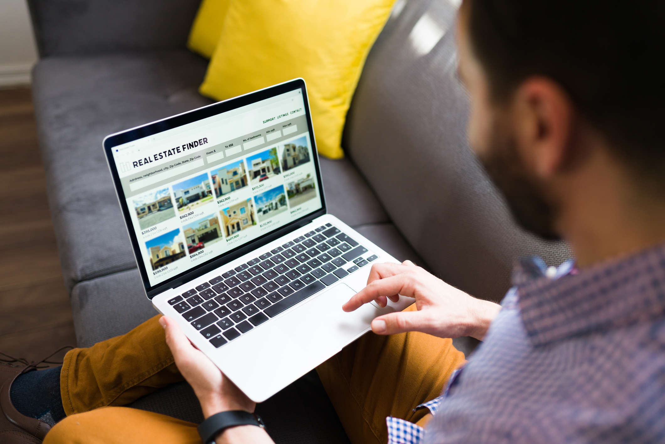 Person looks at listings online on laptop.