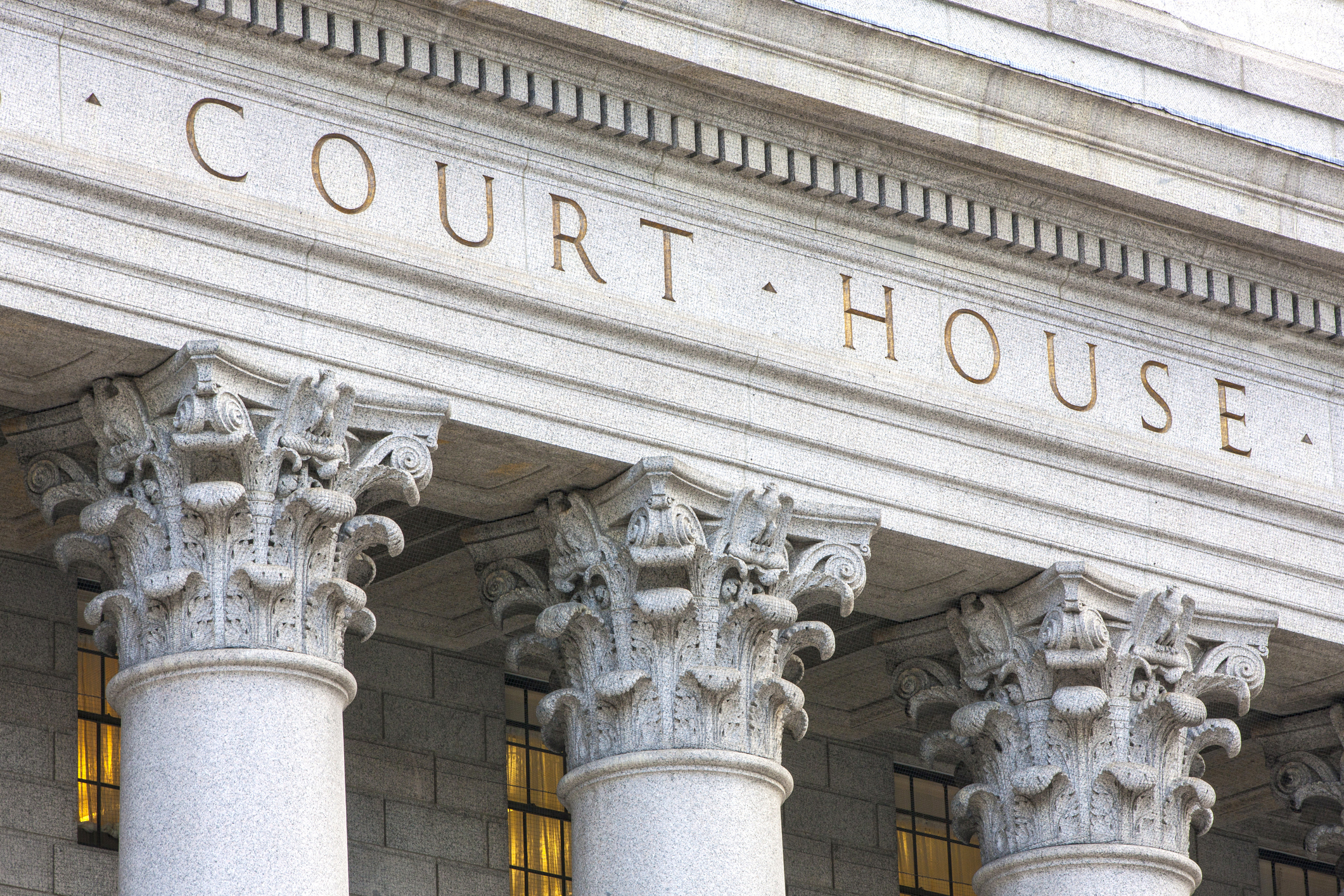 Gray masonry facade reads COURT HOUSE.