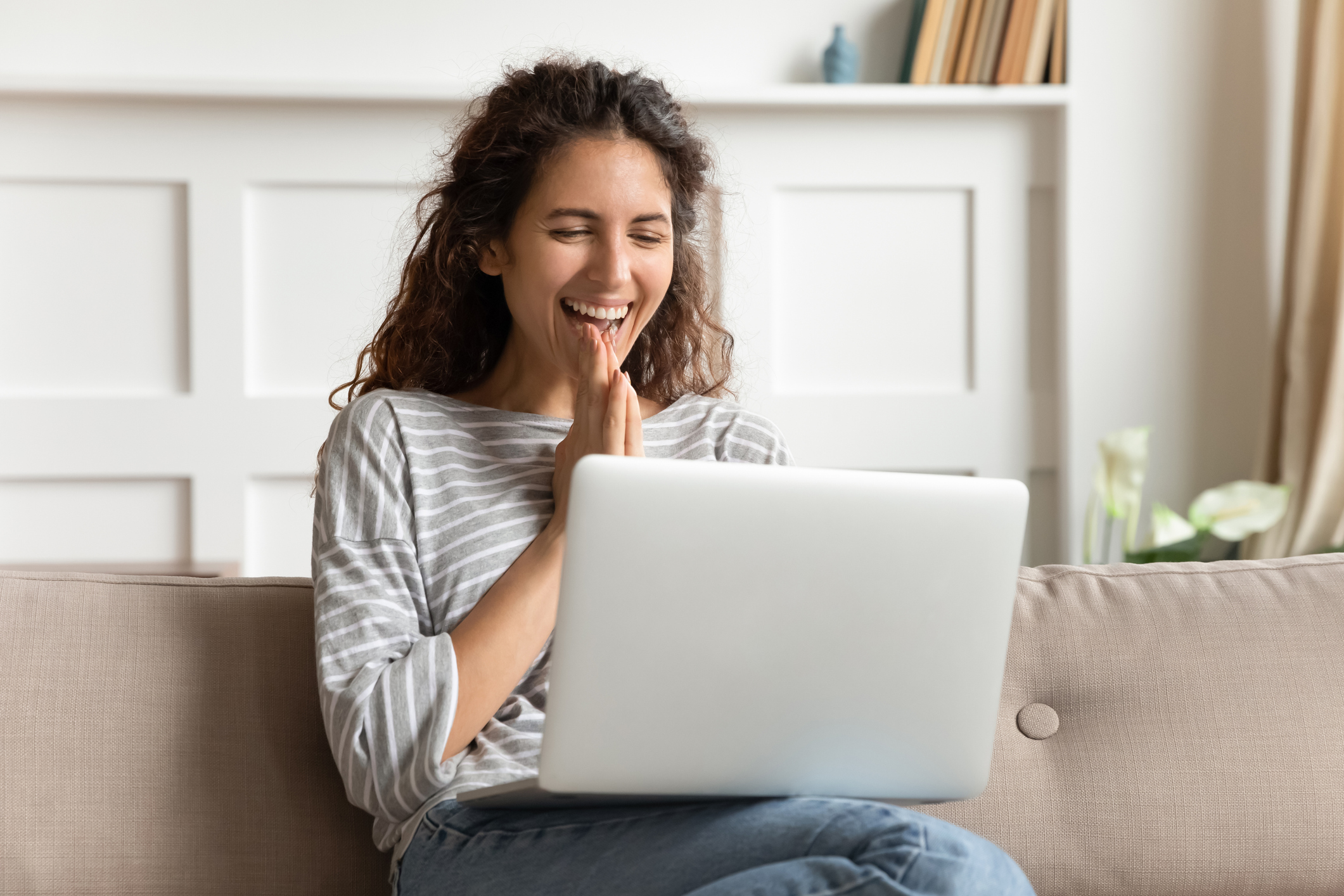 Person excited after reading good news on their computer.