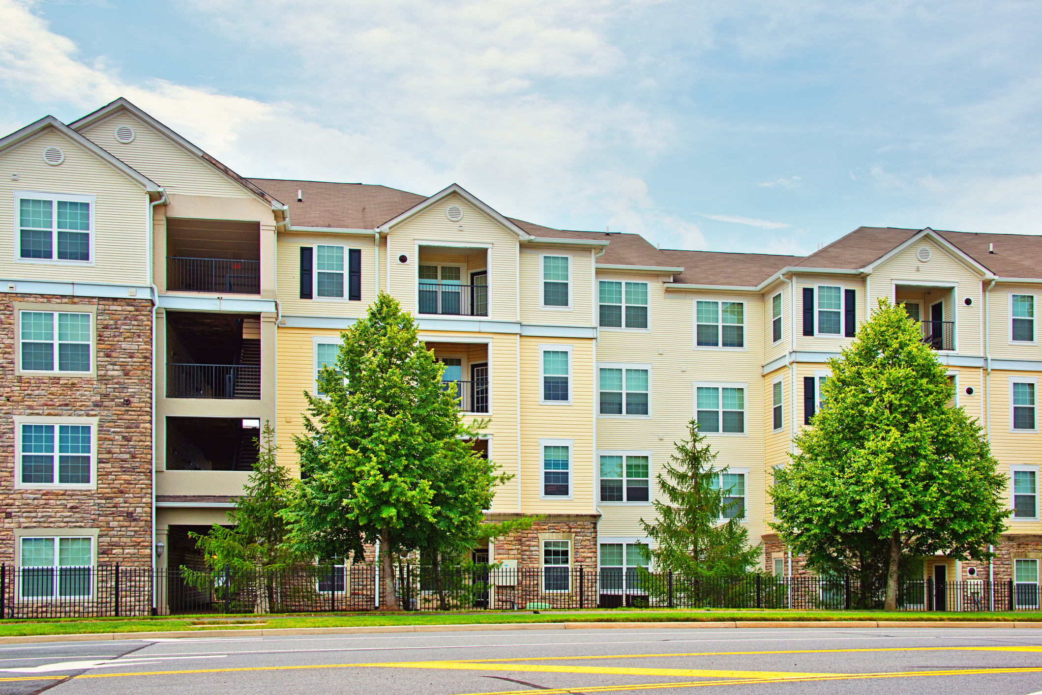 Yellow and brick multifamily apartment complex.
