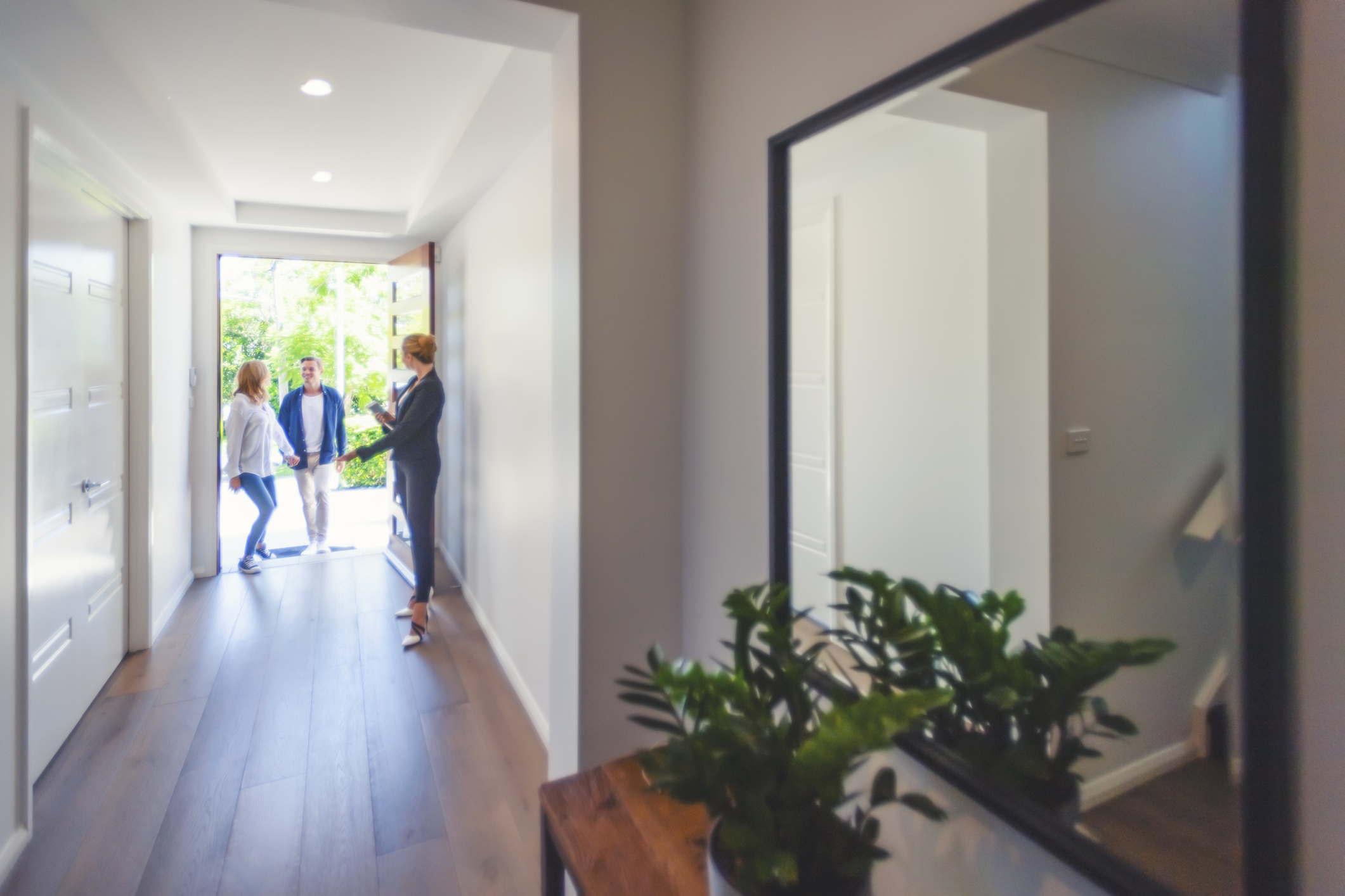 couple being shown new house in foyer.