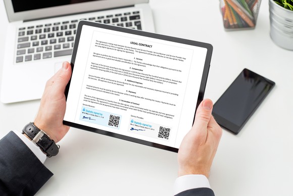 A person signing legal document with electronic signature.