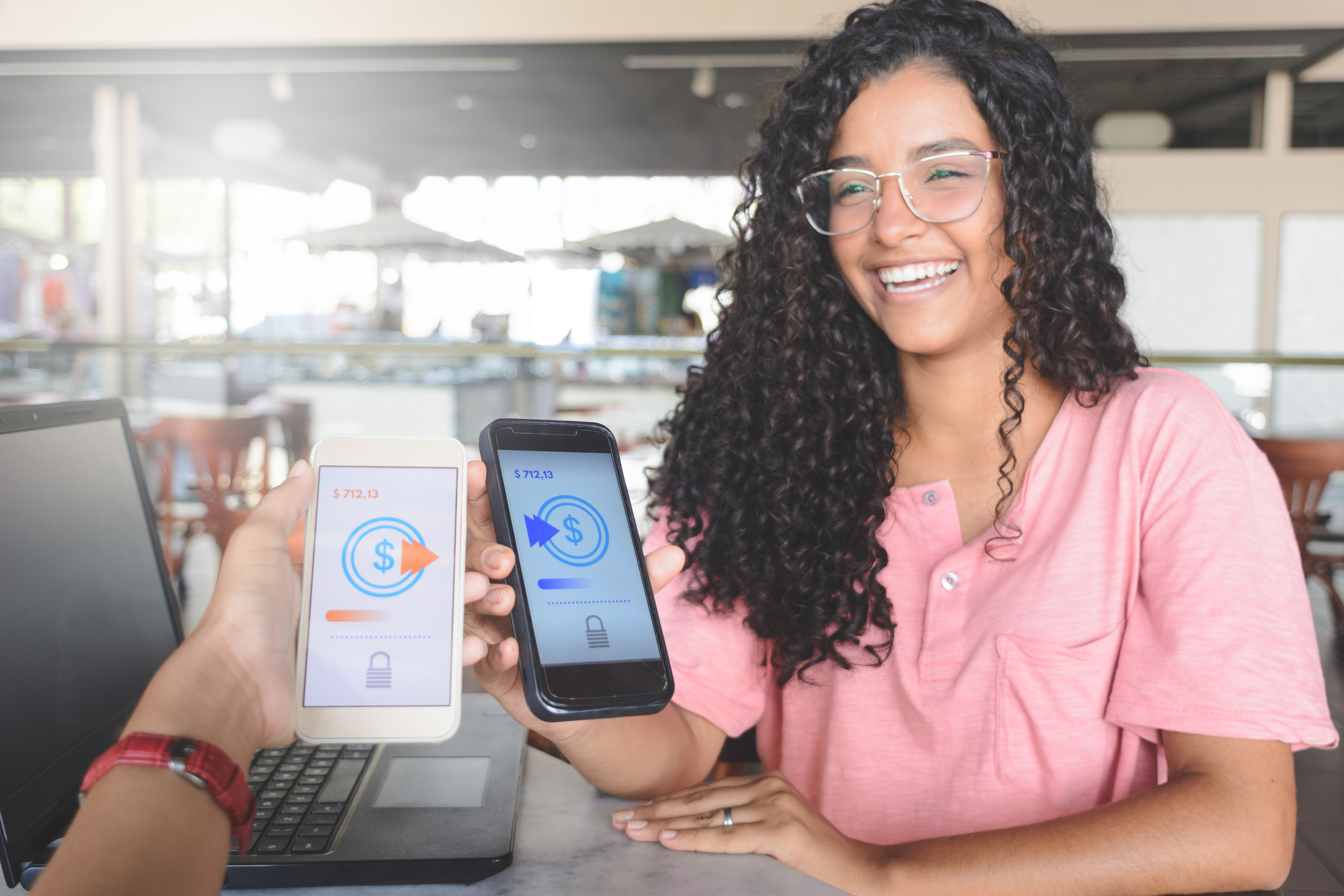 A person transfers money to someone else using a smartphone.