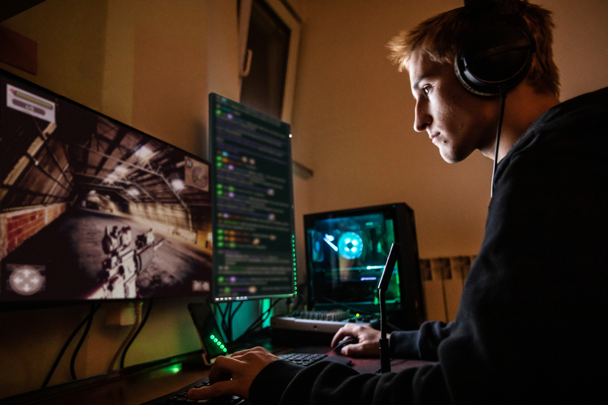 A gamer playing a first-person shooter on a PC.