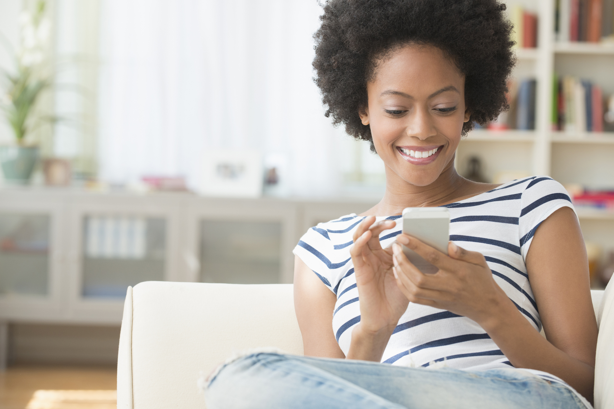 A person looking at their phone in a home environment.
