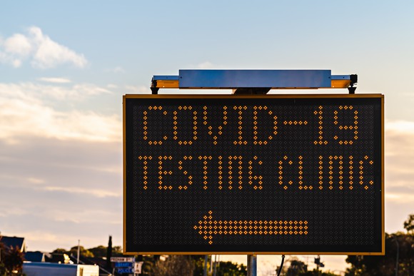 A sign gives directions to the nearest COVID-19 testing clinic.
