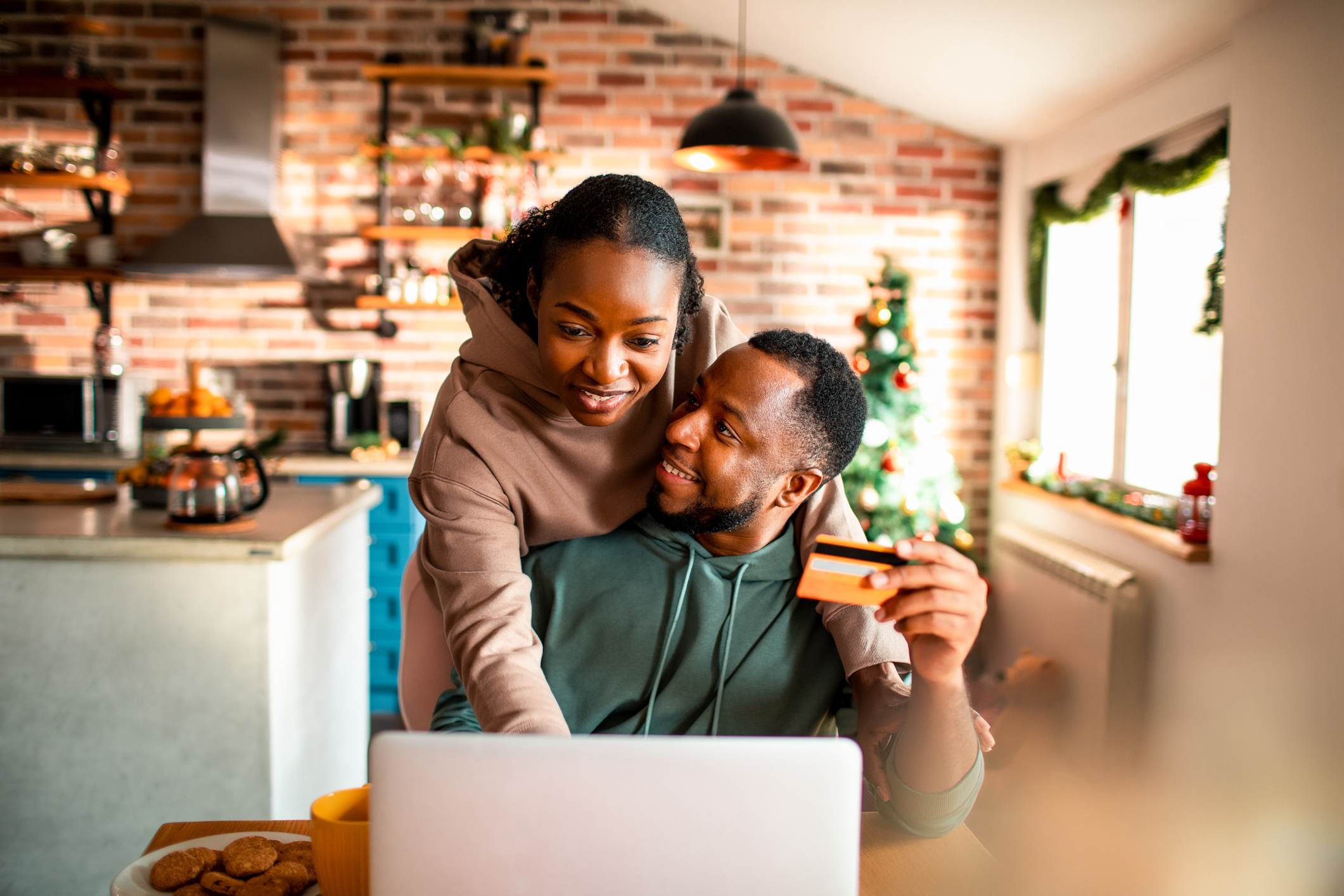 Two people in front of a laptop.