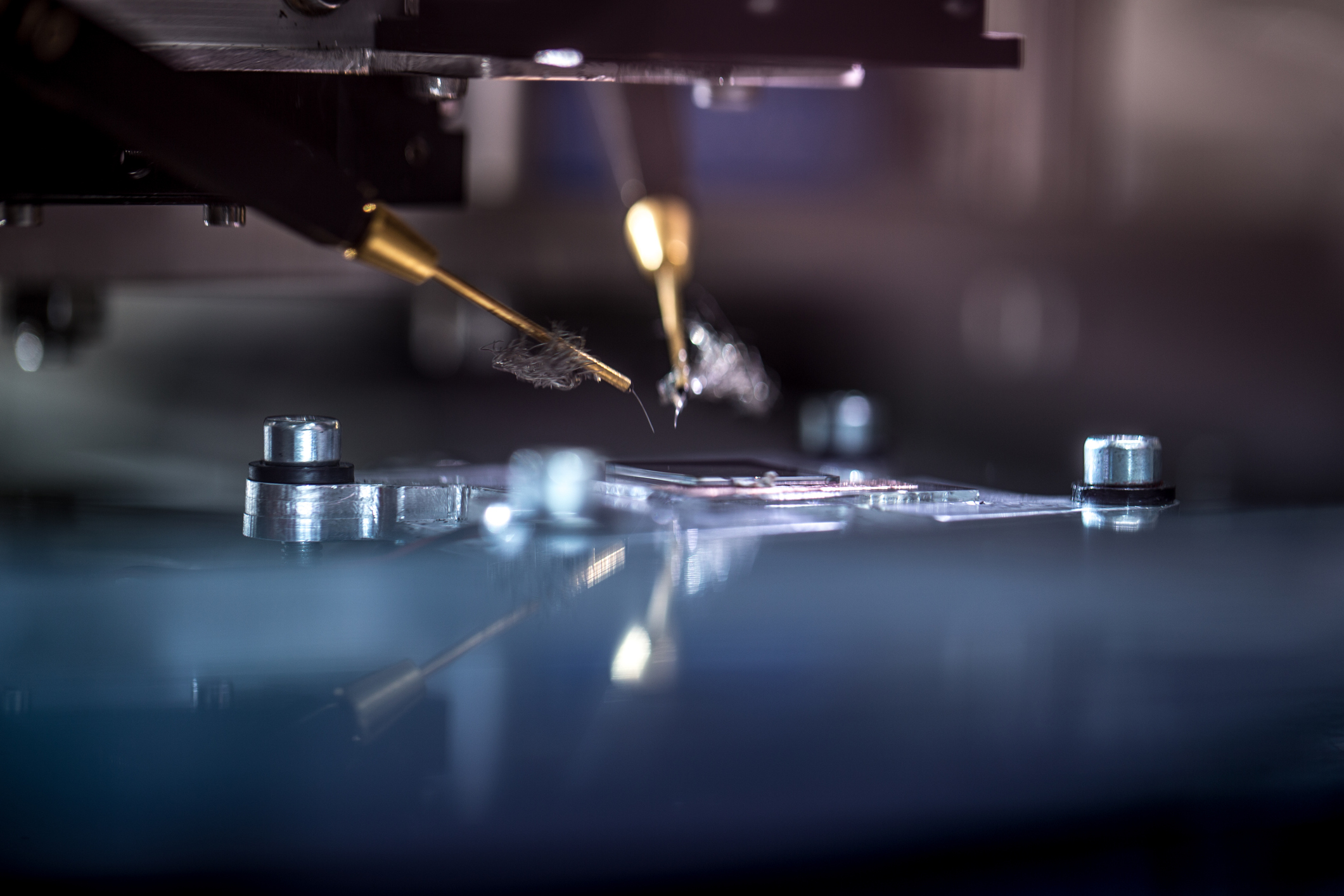 Machines etching a semiconductor on a silicon wafer.